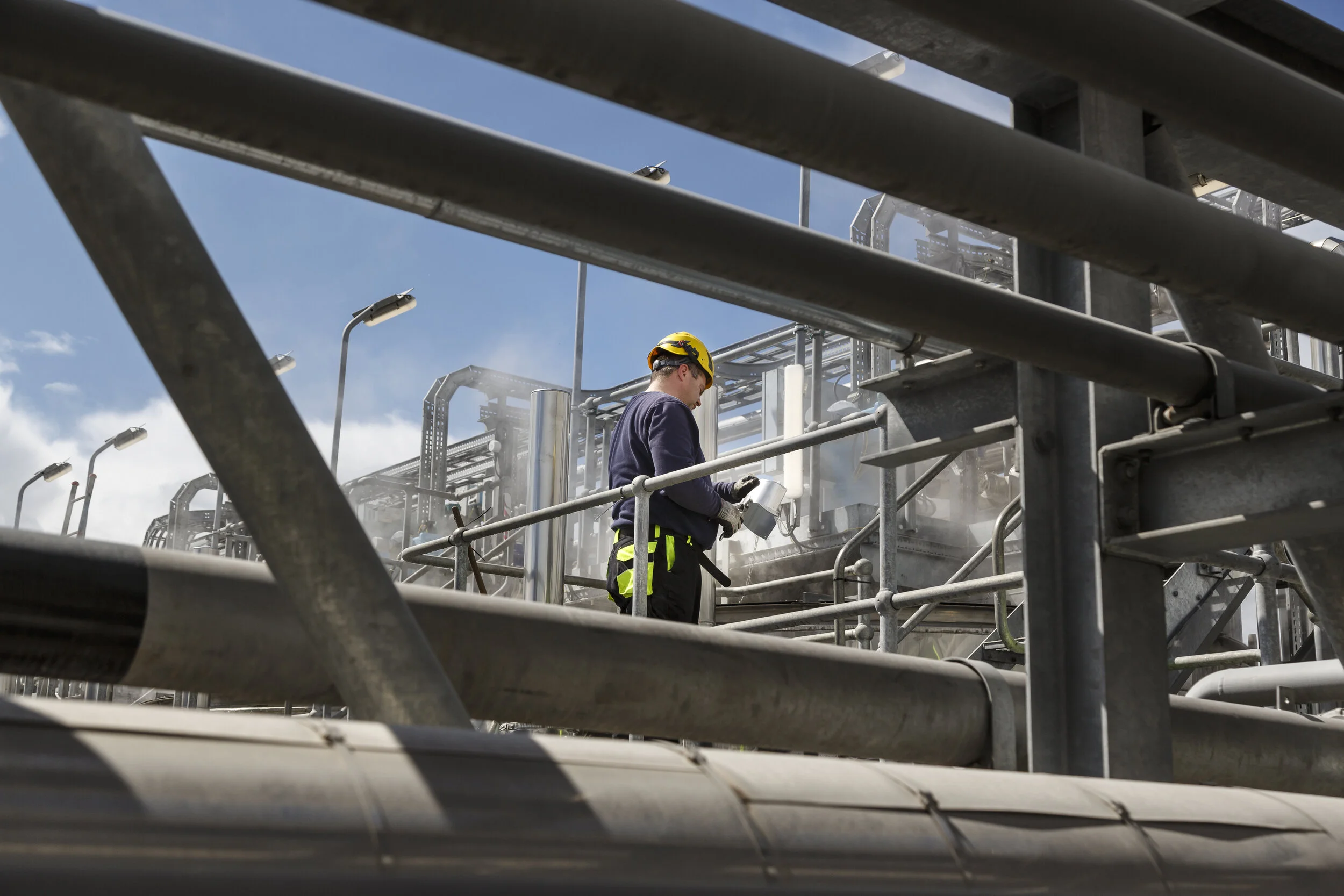  A commercial documentary photograph of the Copenhagen Infrastructure Partners (CIP) Sustainable Energy Plant.   A man works on new steam pipe work  One of UK and Europe’s largest energy-from-waste (EfW) plants.    Photography commissioned by Copenha