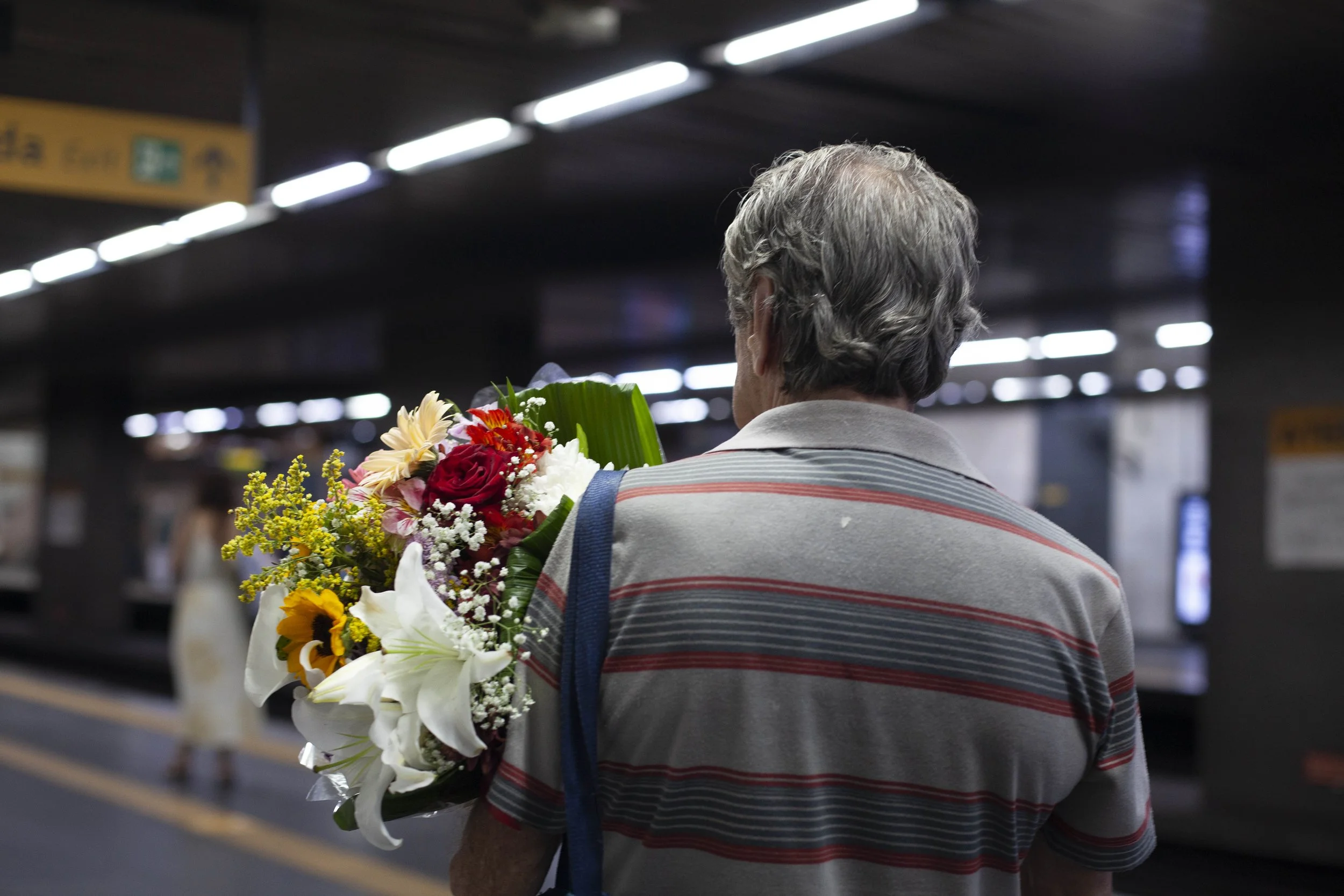  A documentary travel photograph taken of a Man carrying flowers in the subway in Rio de Janeiro 