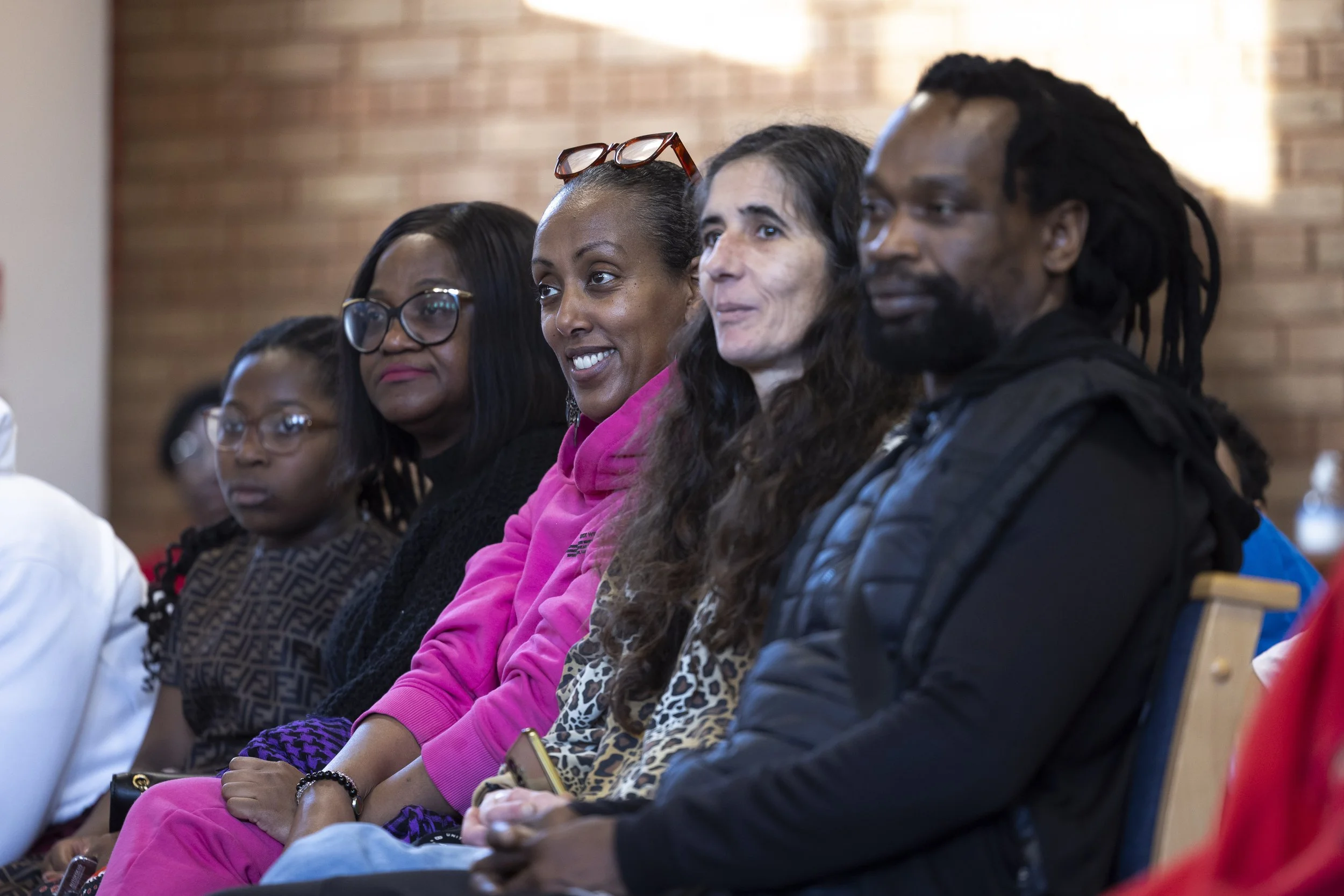  Parents watching performances at Olympias Music Foundation concert in Manchester – documentary photography by David Oates 
