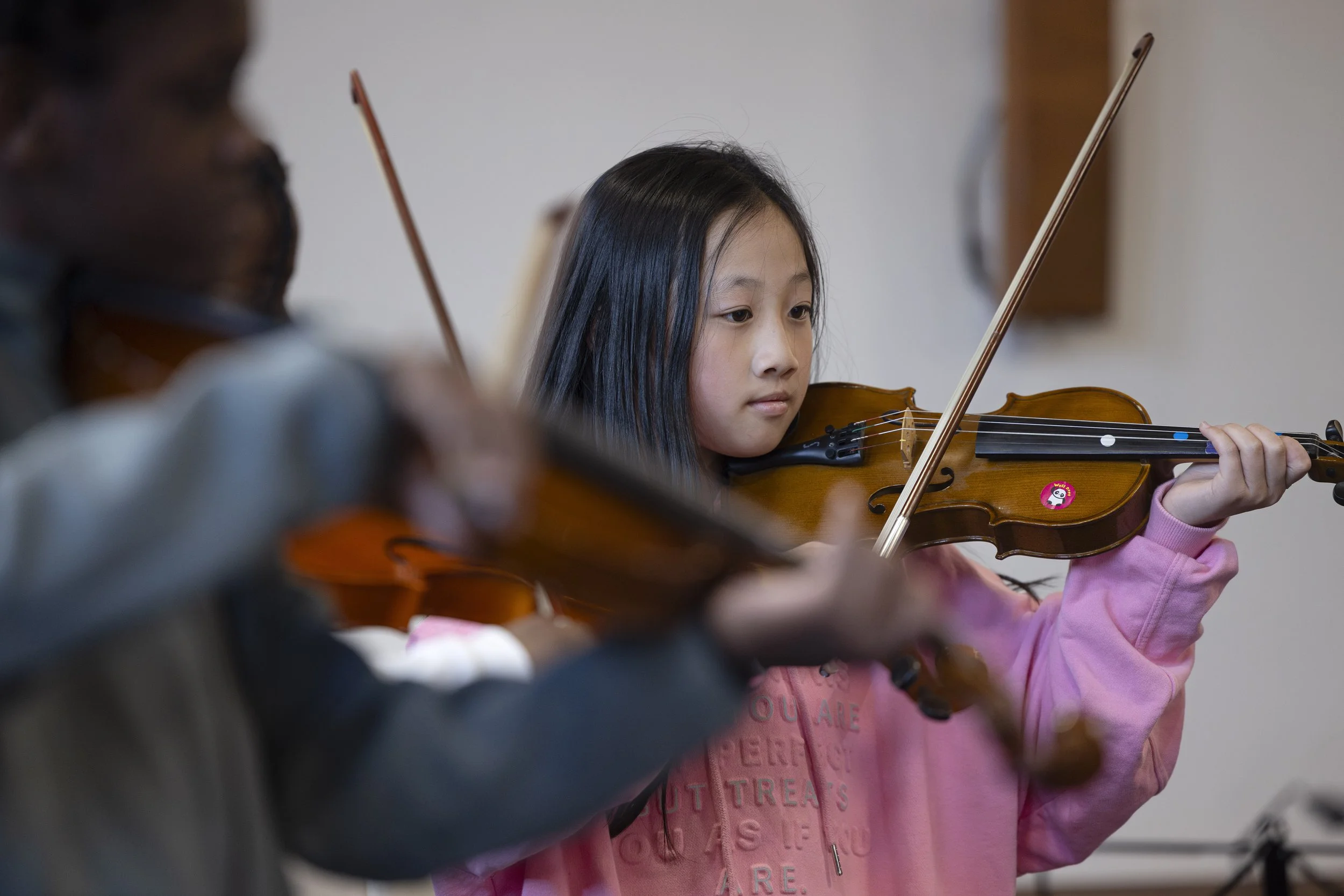  Young girl playing violin at Olympias Music Foundation concert, Manchester – event photography by Manchester photographer David Oates 