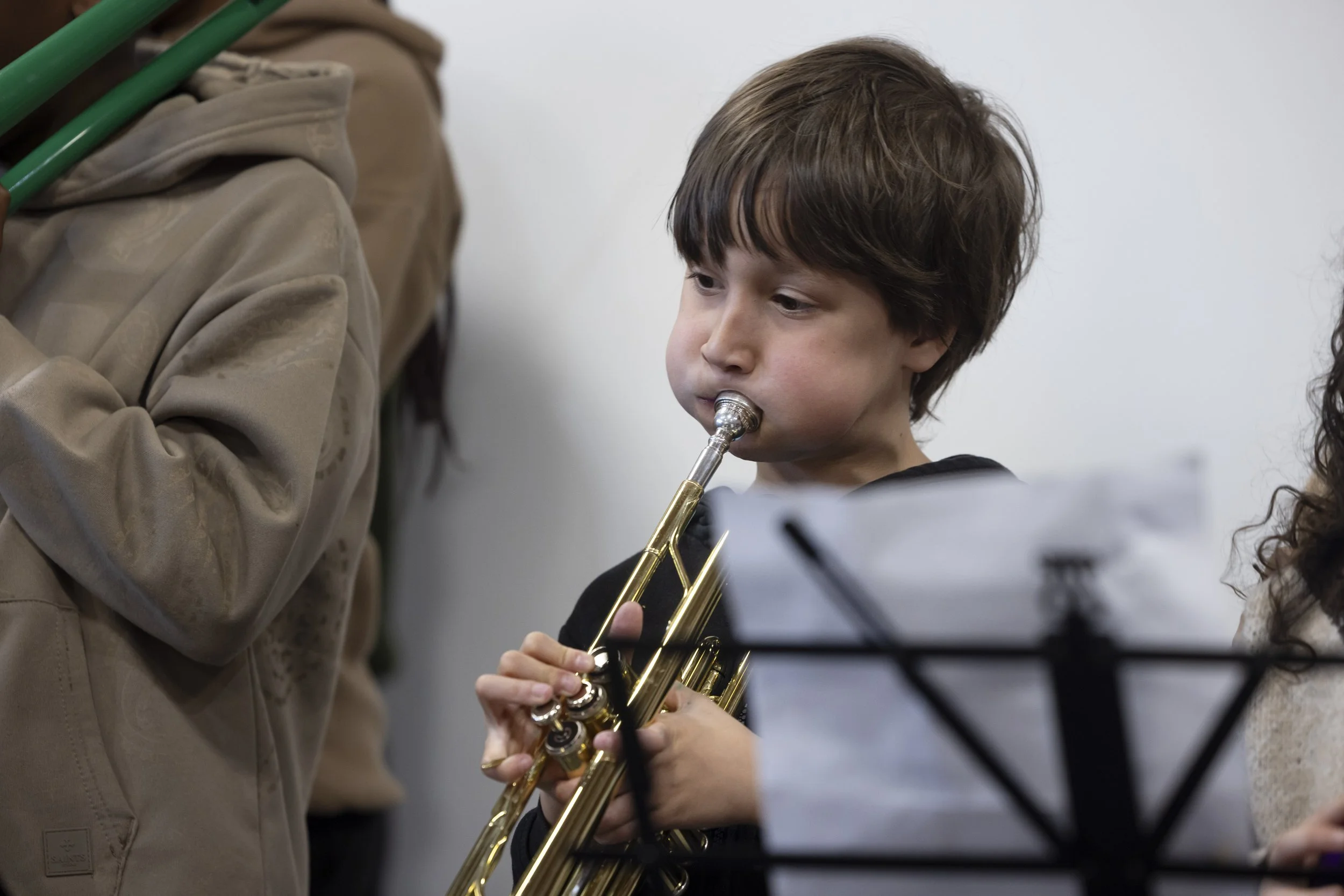  Young boy playing trumpet at Olympias Music Foundation concert, Manchester – event photography by Manchester-based photographer David Oates 