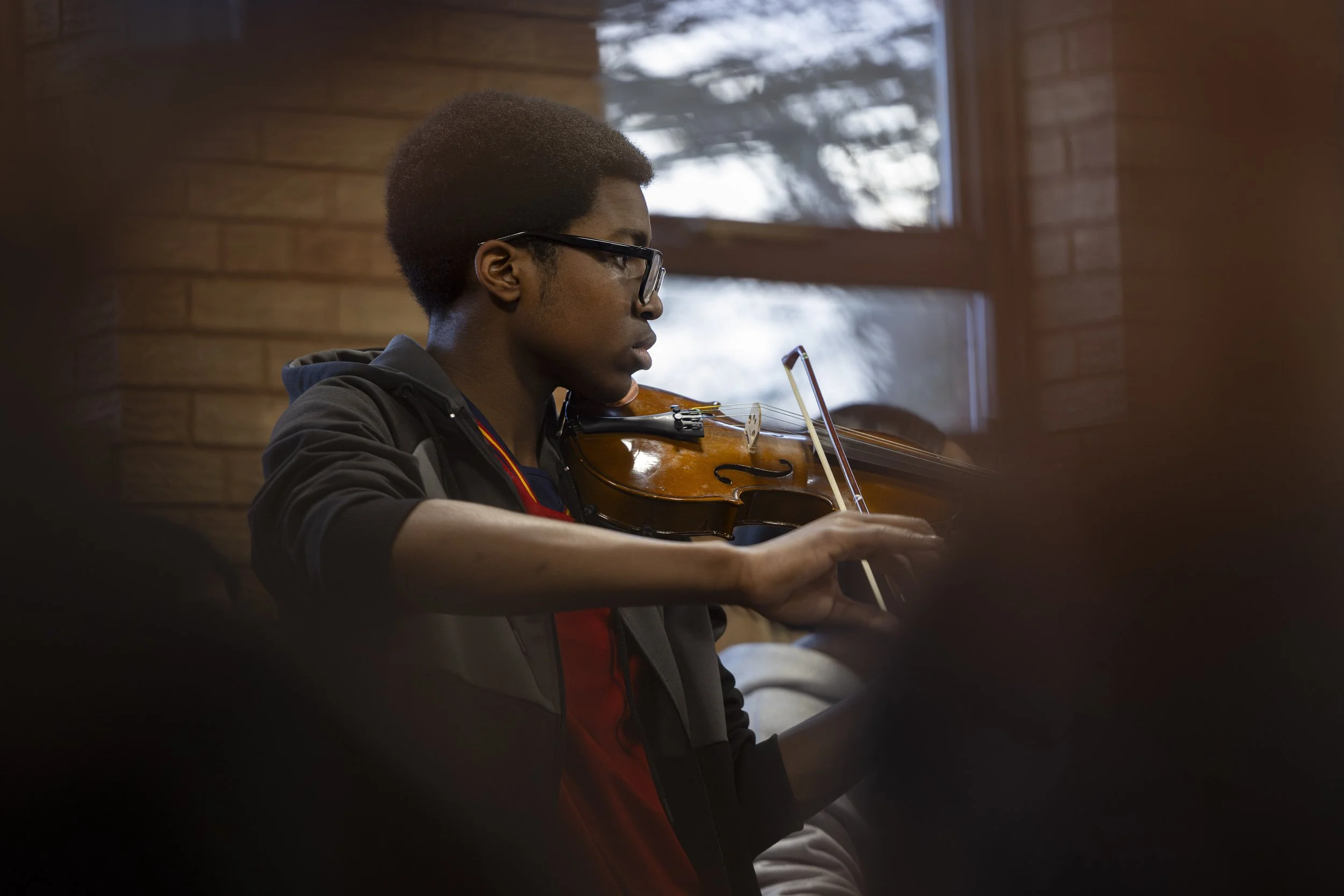  Young man playing violin at Olympias Music Foundation concert, Manchester – event photography by Manchester-based photographer David Oates 