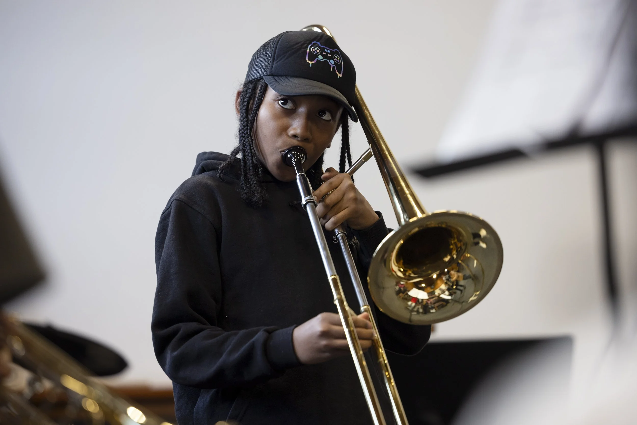  Young boy playing trombone at Olympias Music Foundation concert in Manchester – event photography by David Oates 