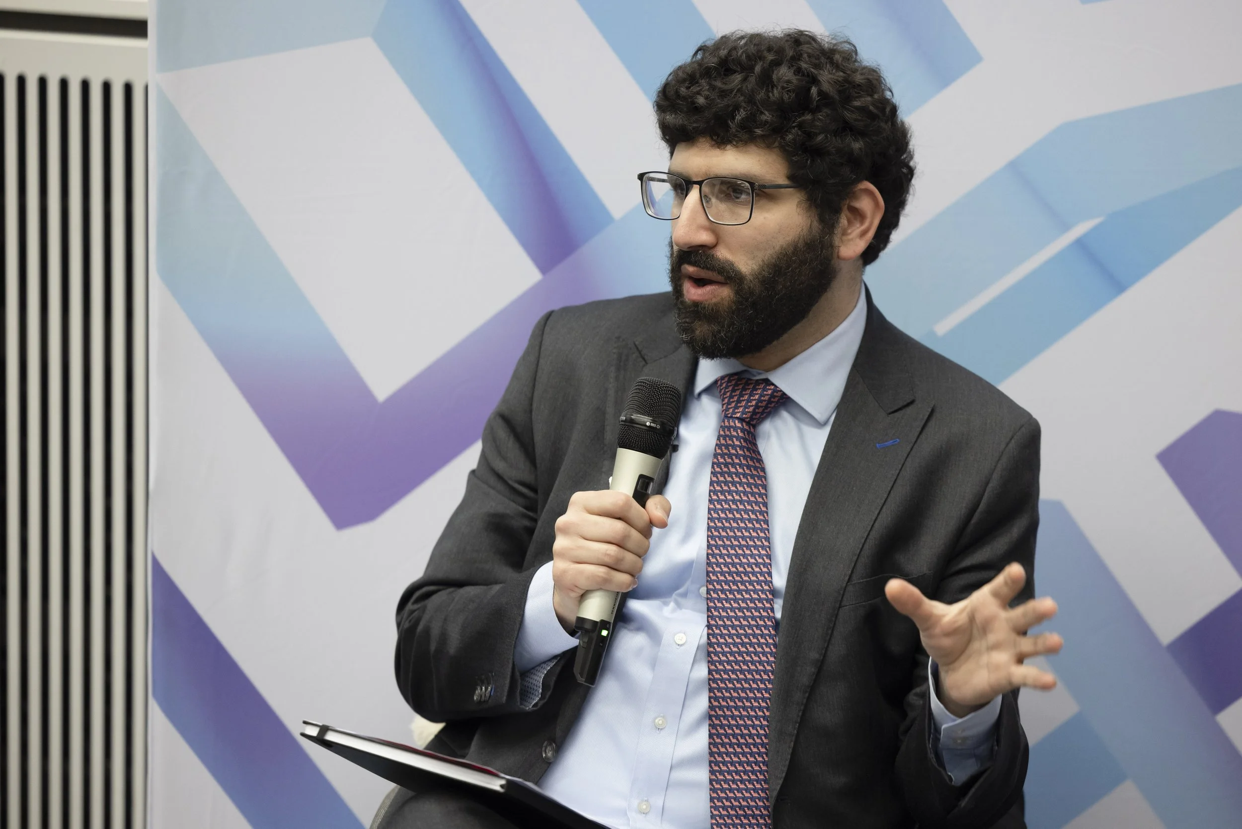 A man giving a presentation at a conference in Manchester