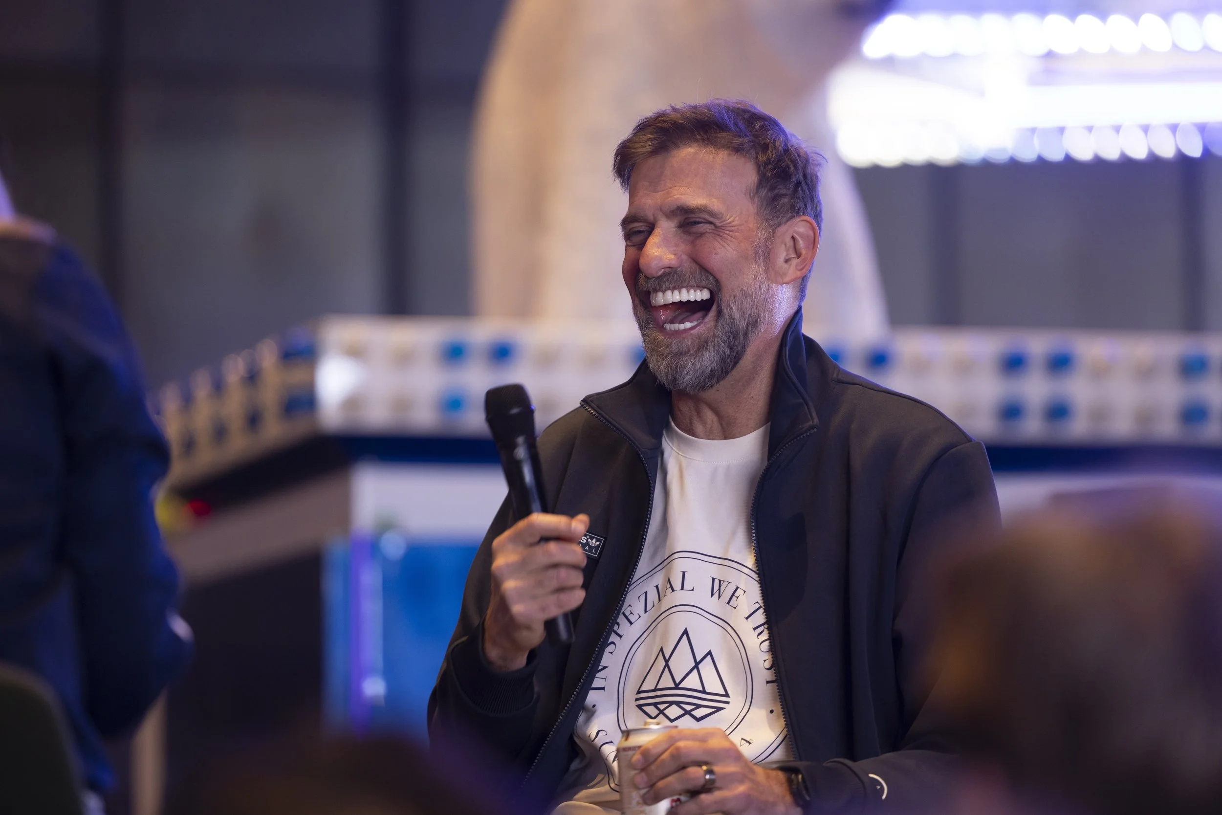 Jurgen Klopp laughing during an on stage interview at a live Adidas event, event photography.