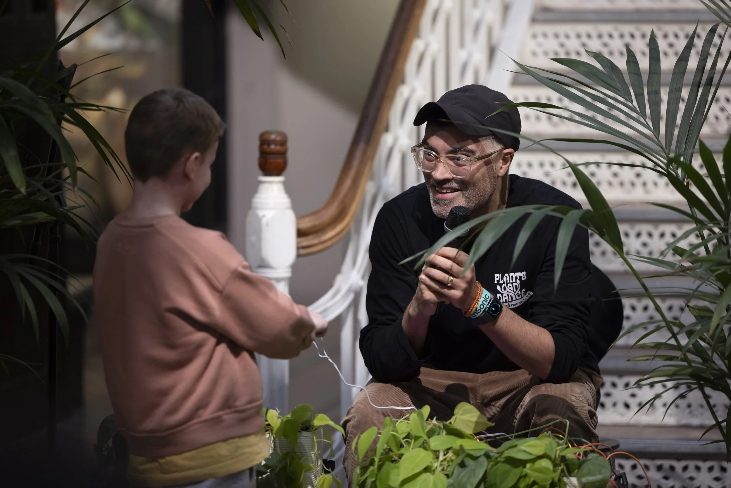 The Cloud Gardener demonstrating plant-generated sound to a young boy during interactive performance at EarthSonic Live, Manchester Museum