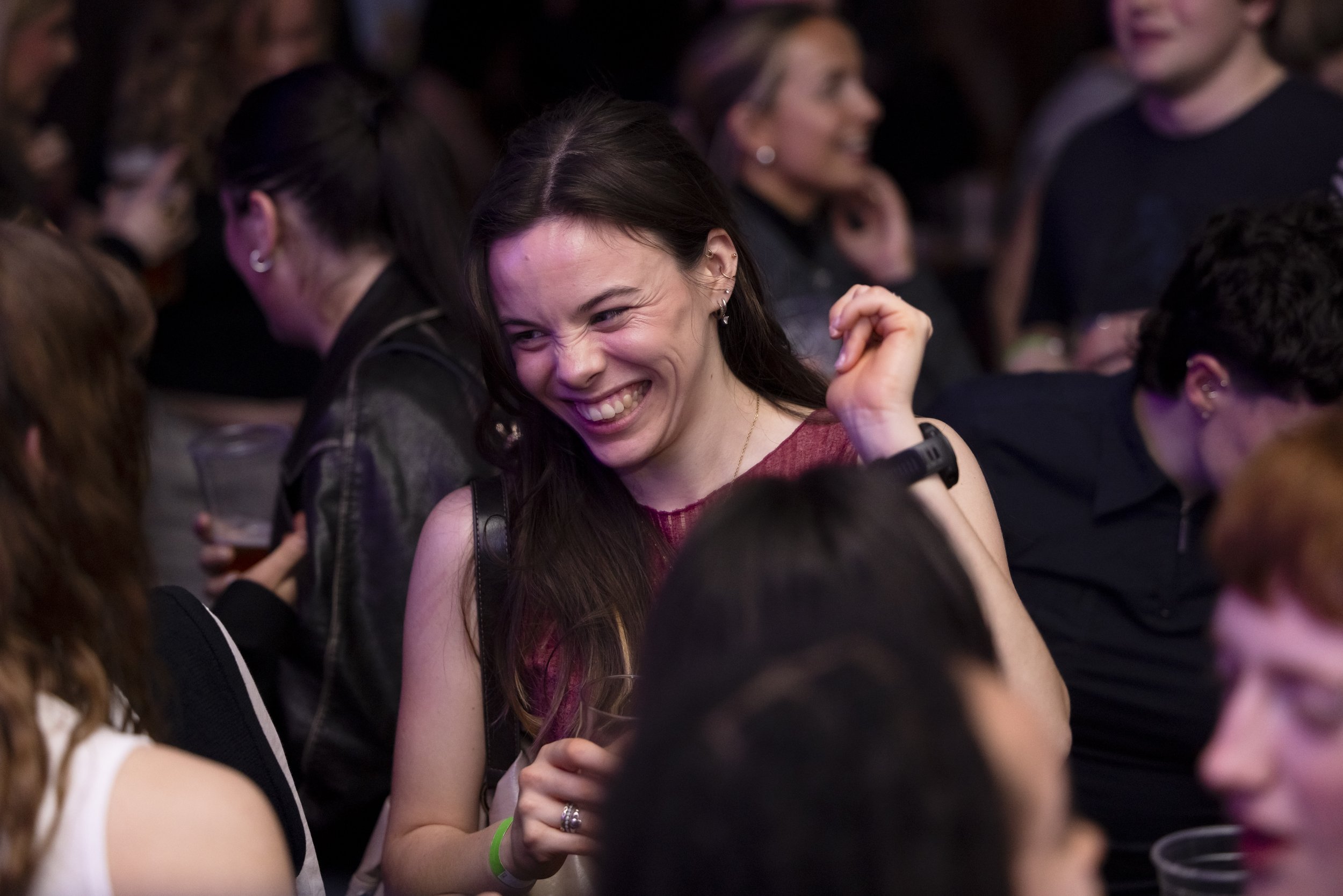 Woman laughing on dancefloor during live DJ set at Manchester club night