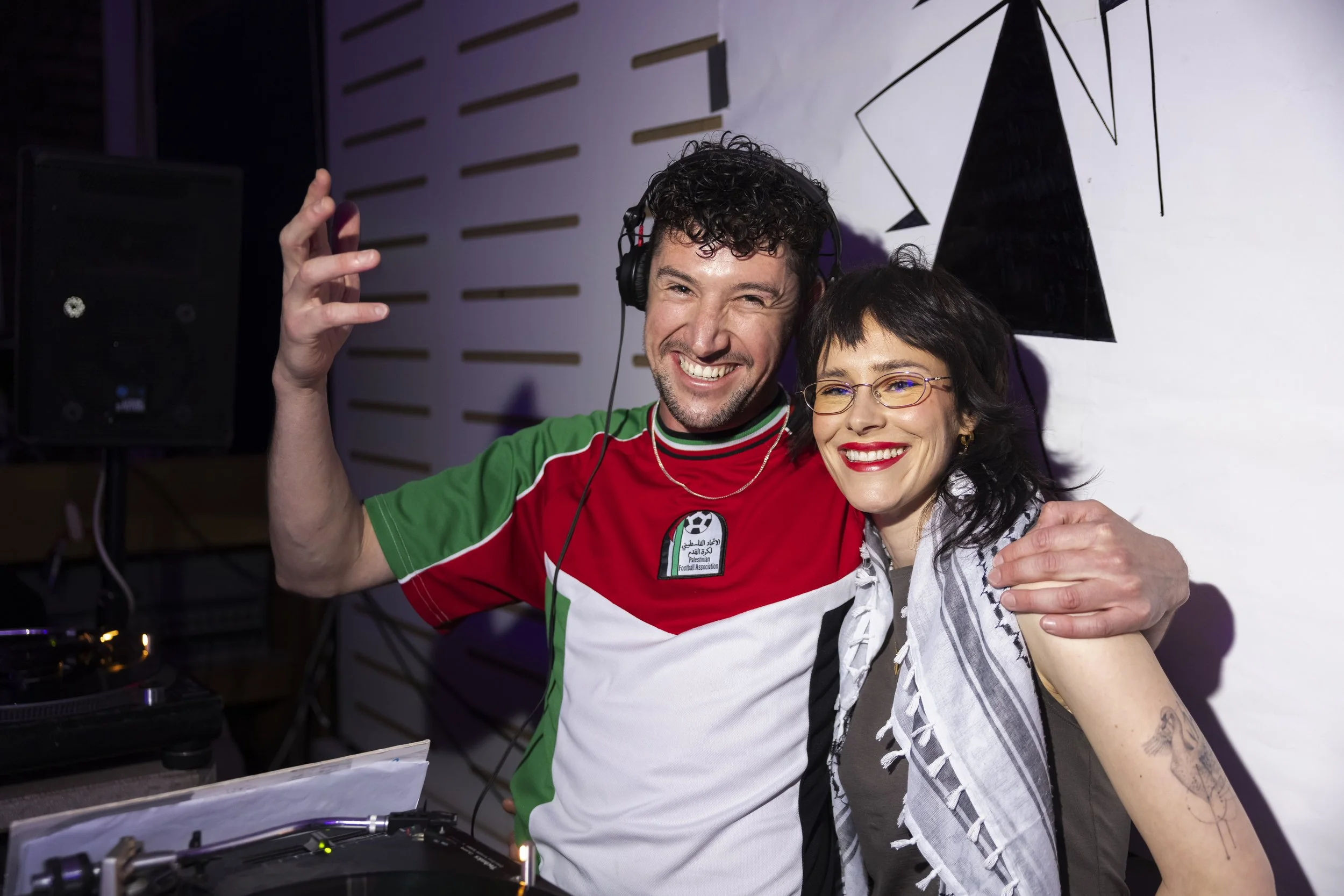 Two DJs performing behind decks at Manchester club night captured by documentary photographer