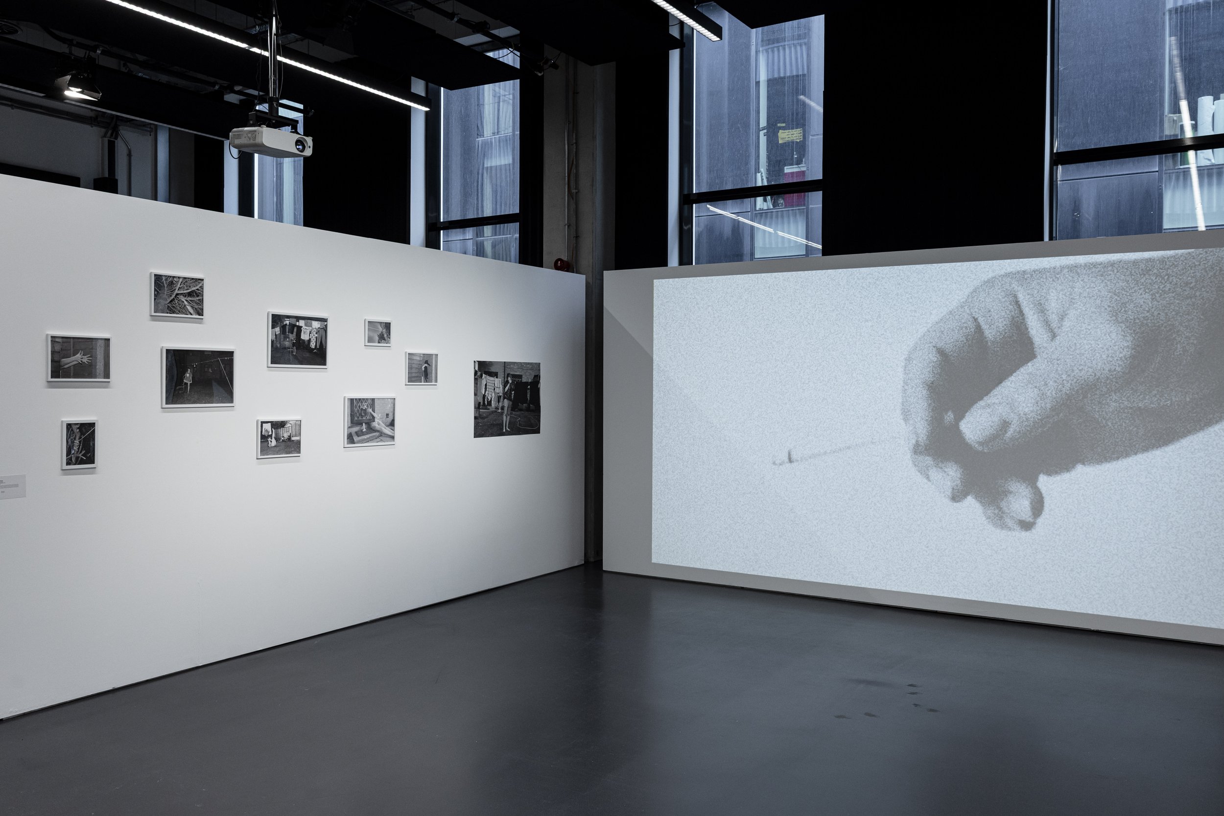 Wide view of photography and film works exhibited in the SODA building during Manchester Metropolitan University's More to Come postgraduate art show.