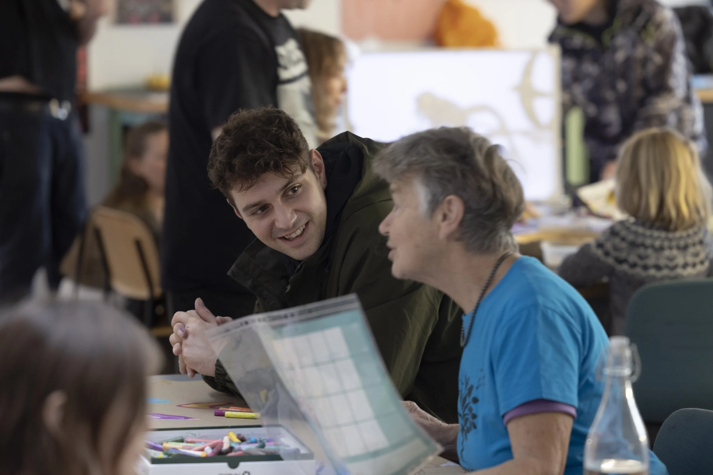 Audience member smiling at volunteer during panel discussion at EarthSonic Live event, Manchester Museum