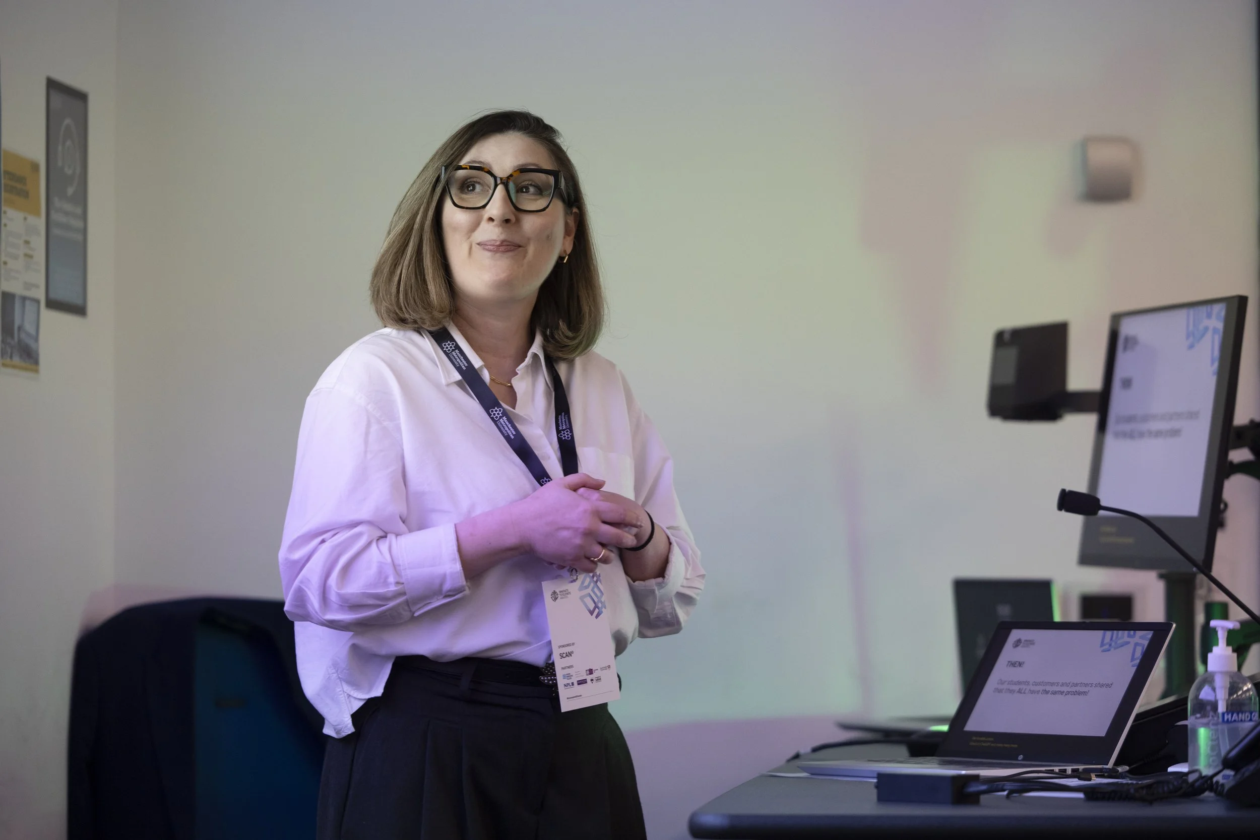 A woman presenting during a conference in Manchester