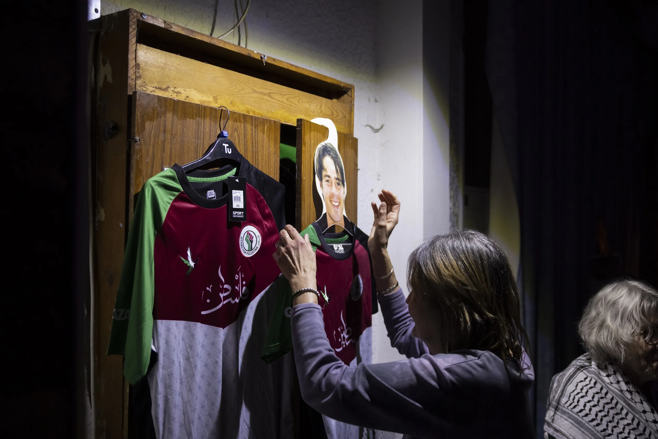 Palestine football shirts displayed on hanger at Manchester community music fundraising event