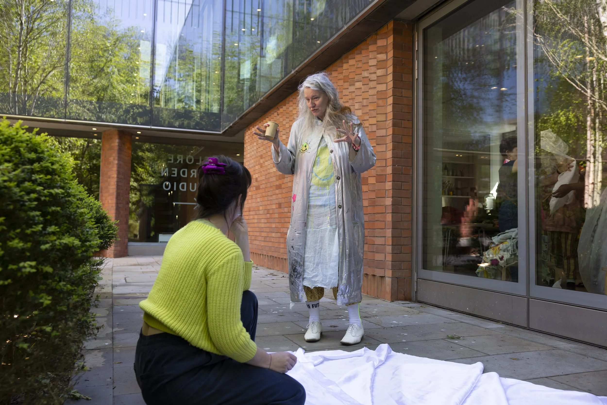 Delaine Le Bas observing and discussing a textile artwork being laid out on the floor during a workshop at The Whitworth, Manchester, process-led contemporary art practice