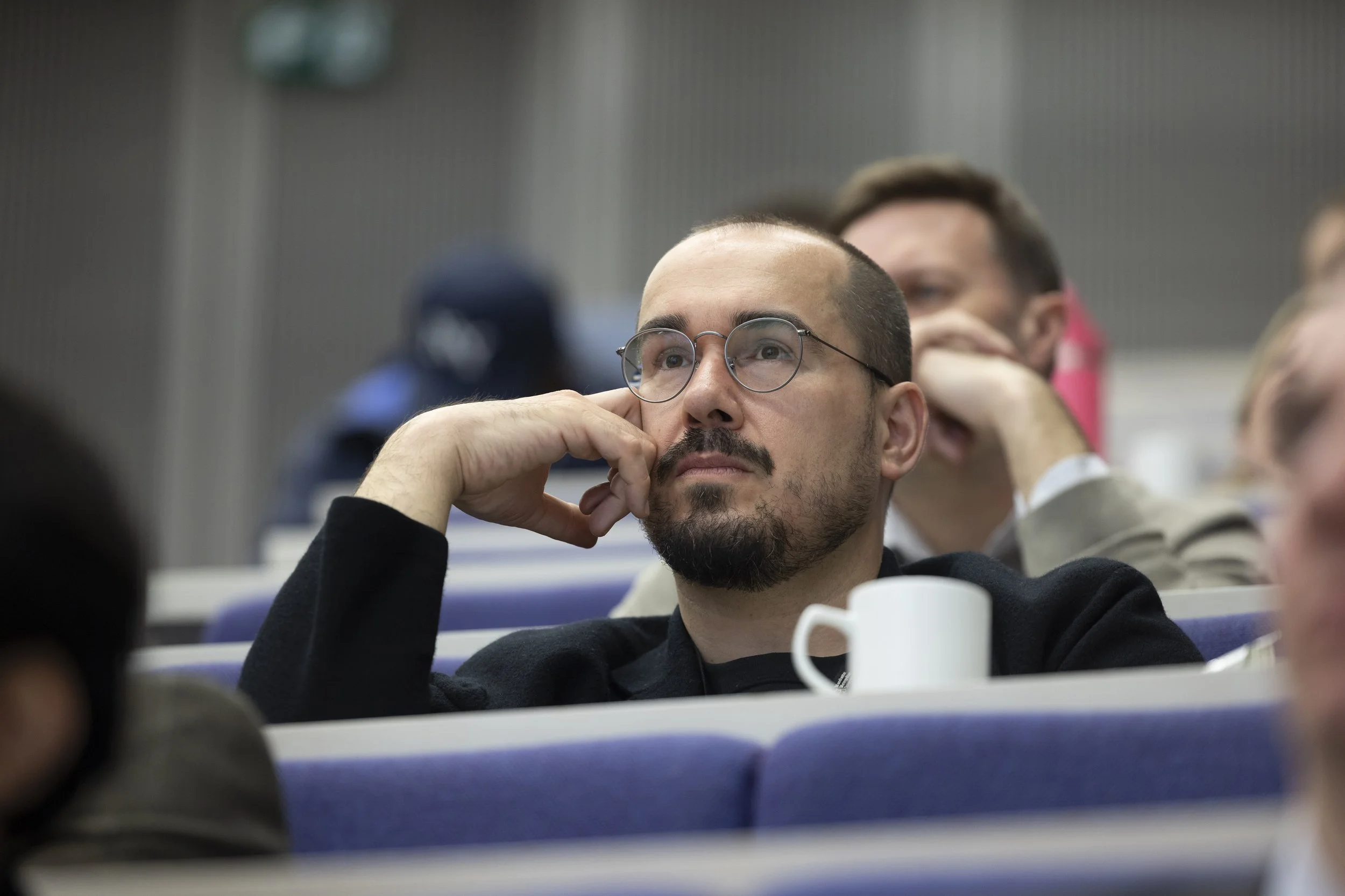 A man watches a presentation during a conference in Manchester