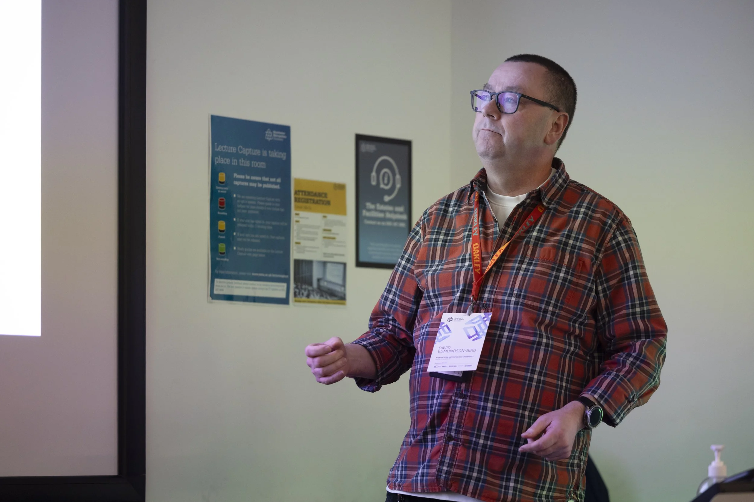 A man giving a presentation at a conference in Manchester