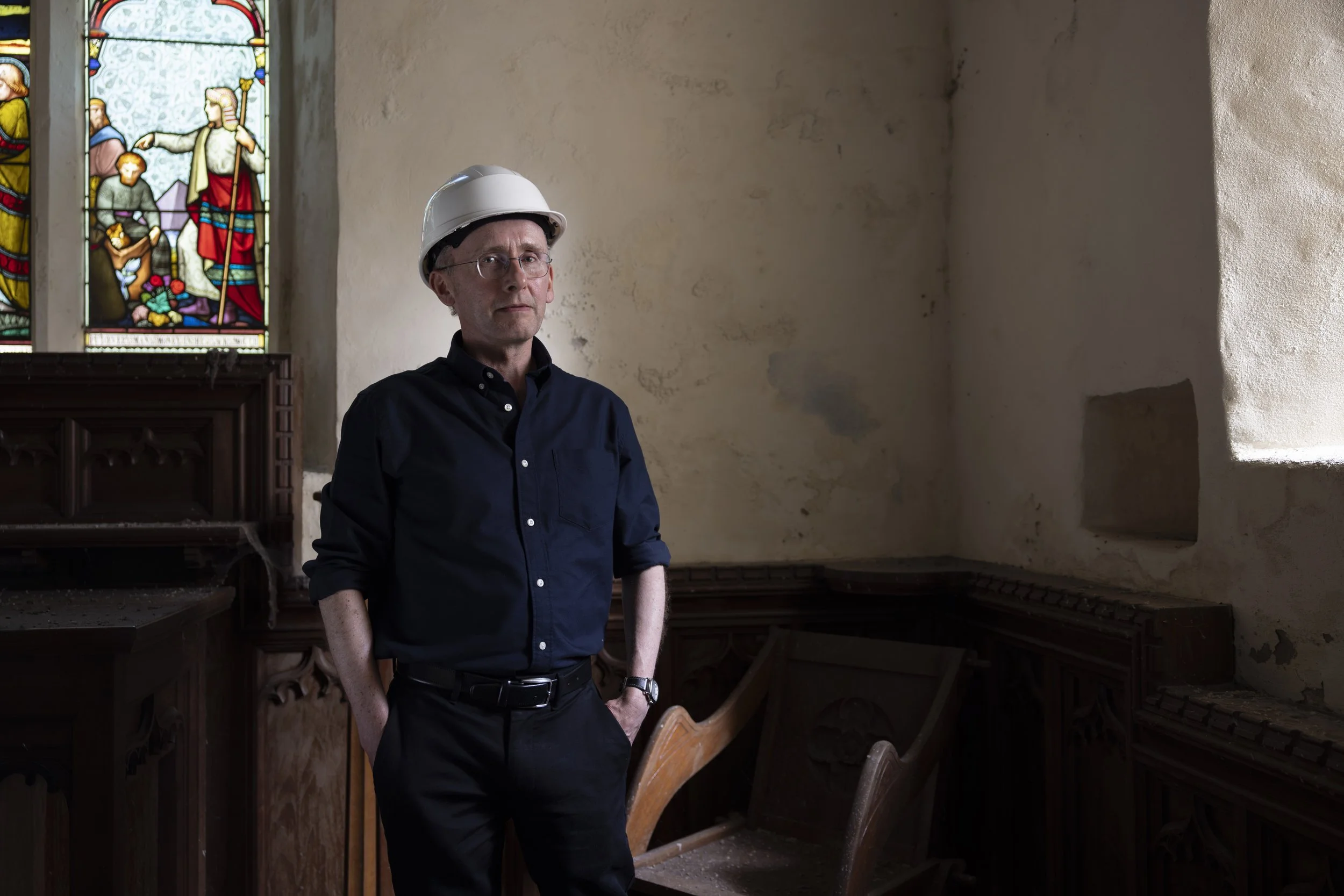 David Farrington wearing a hard hat inside St Tyfrydog’s Church.