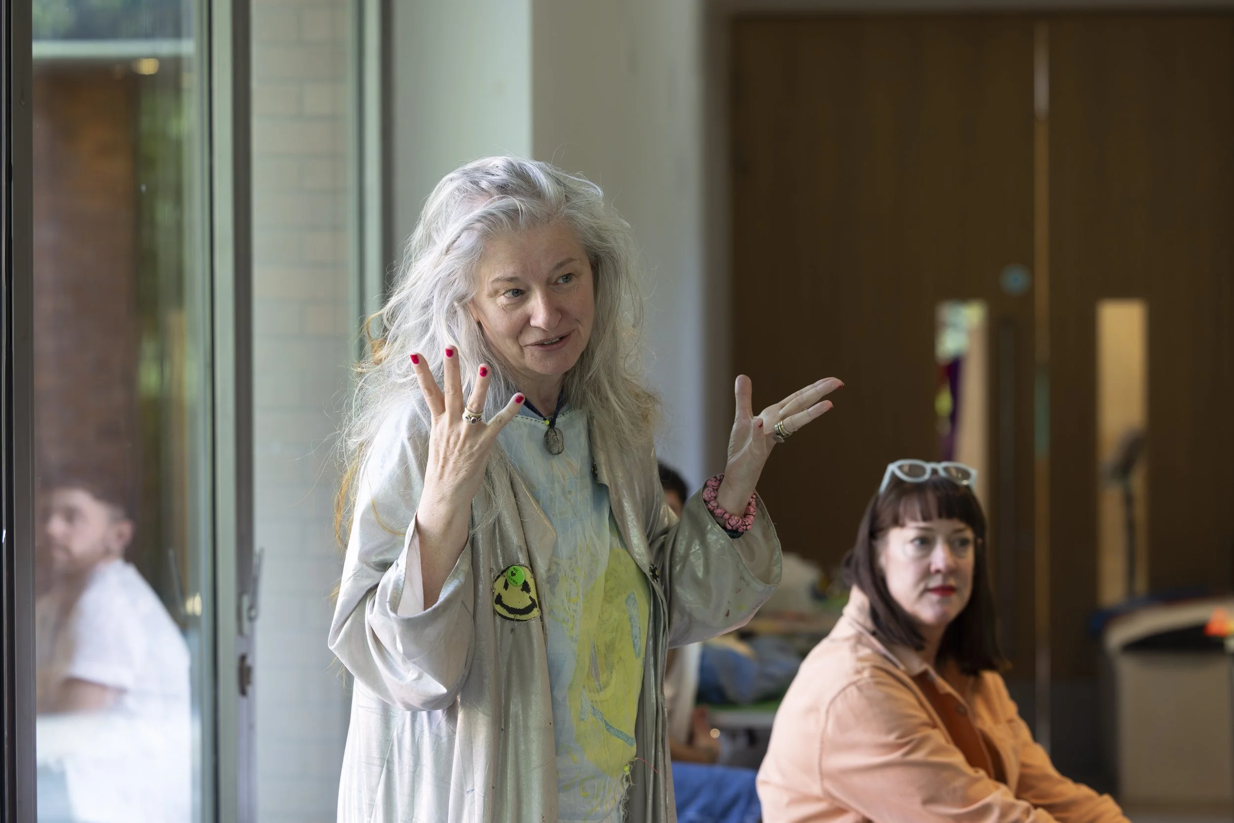 Delaine Le Bas gesturing while speaking to participants during an upcycling workshop at The Whitworth, Manchester, documentary photography of contemporary textile and art practice