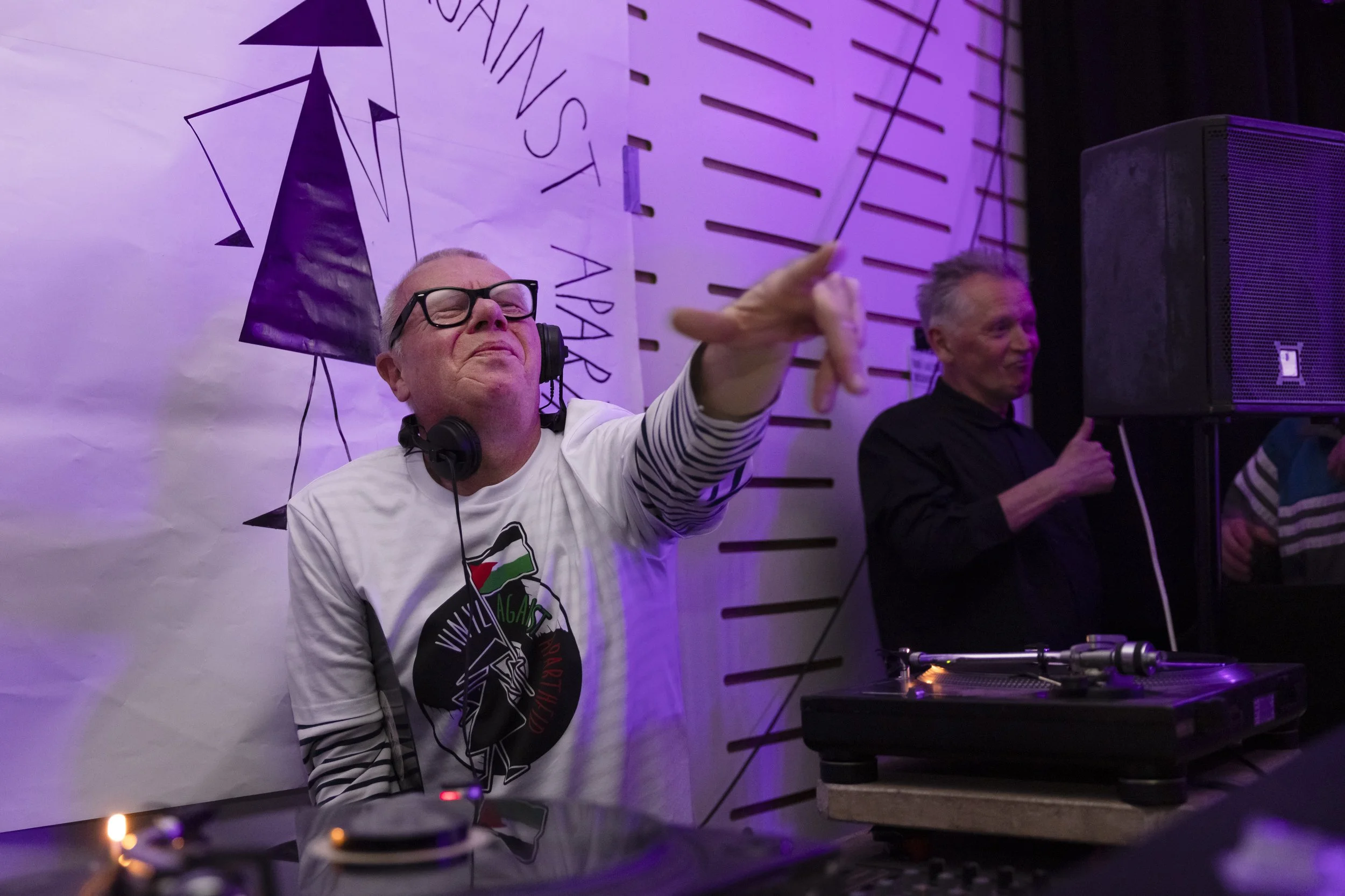 DJ pointing to crowd during live set at Manchester music event photographed by event photographer