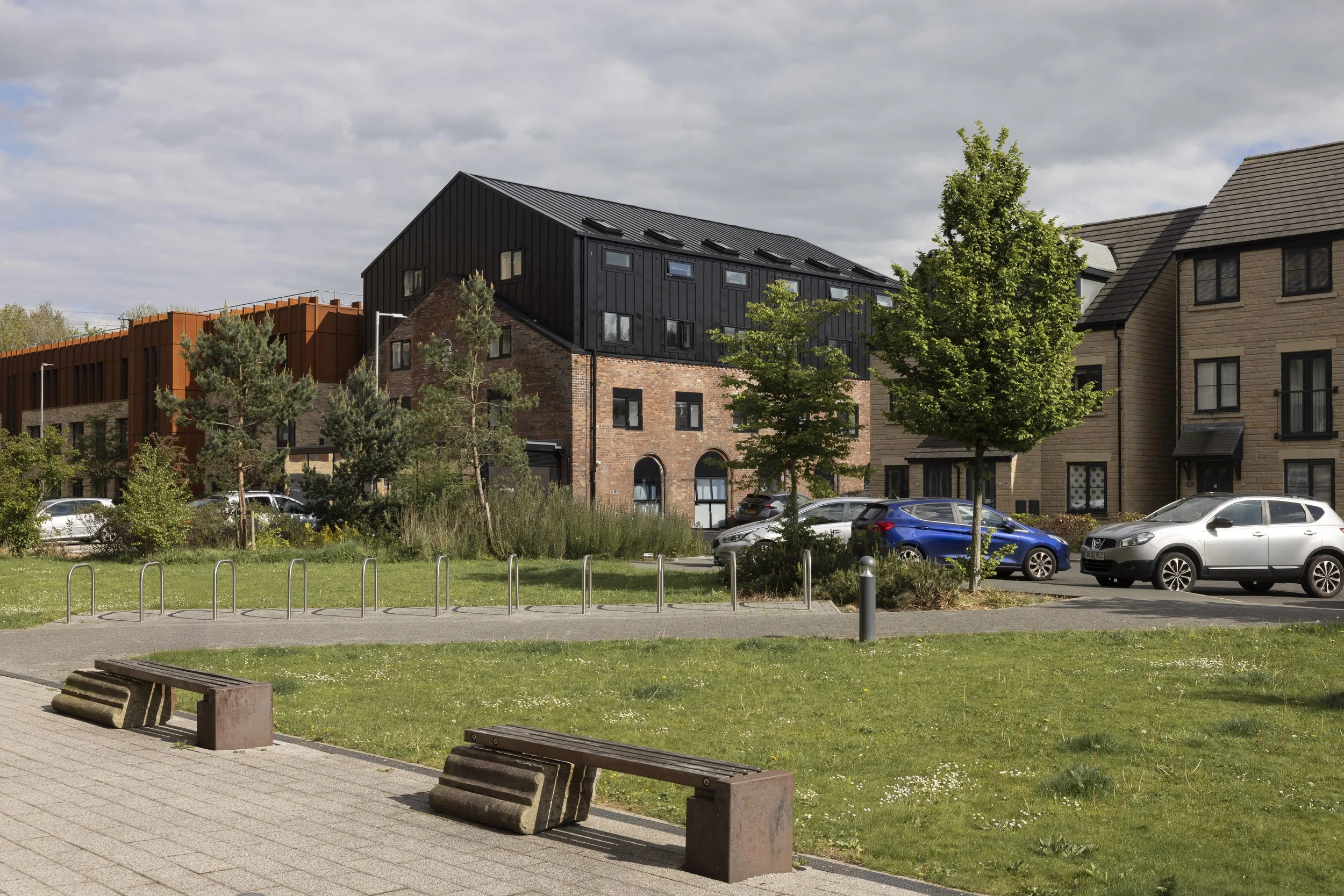 Wide view of The Pump House by Just H Architects showing building within surrounding Lancaster urban context