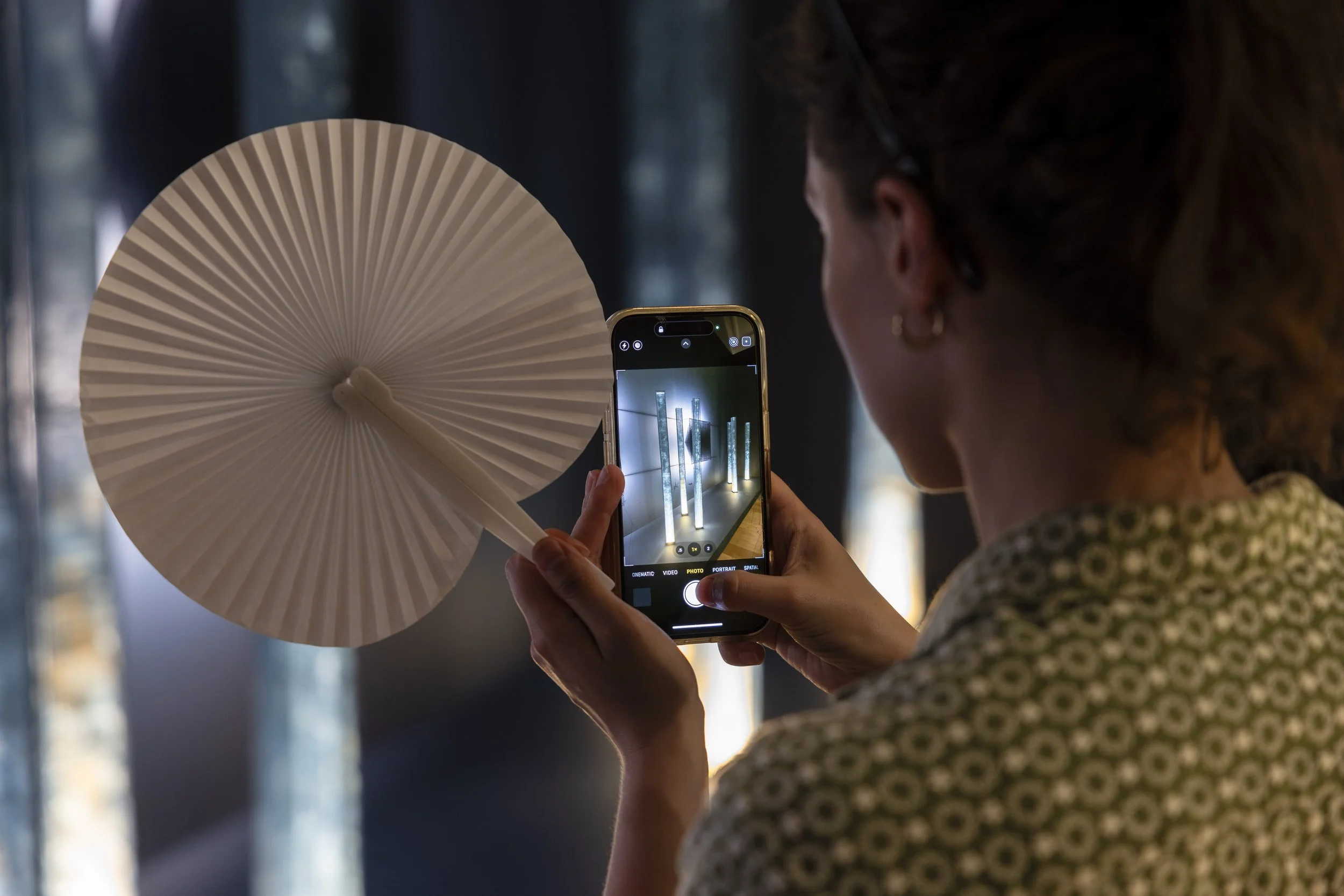 Visitor photographing artwork with a mobile phone at the Entangled and Woven opening, Whitworth Manchester