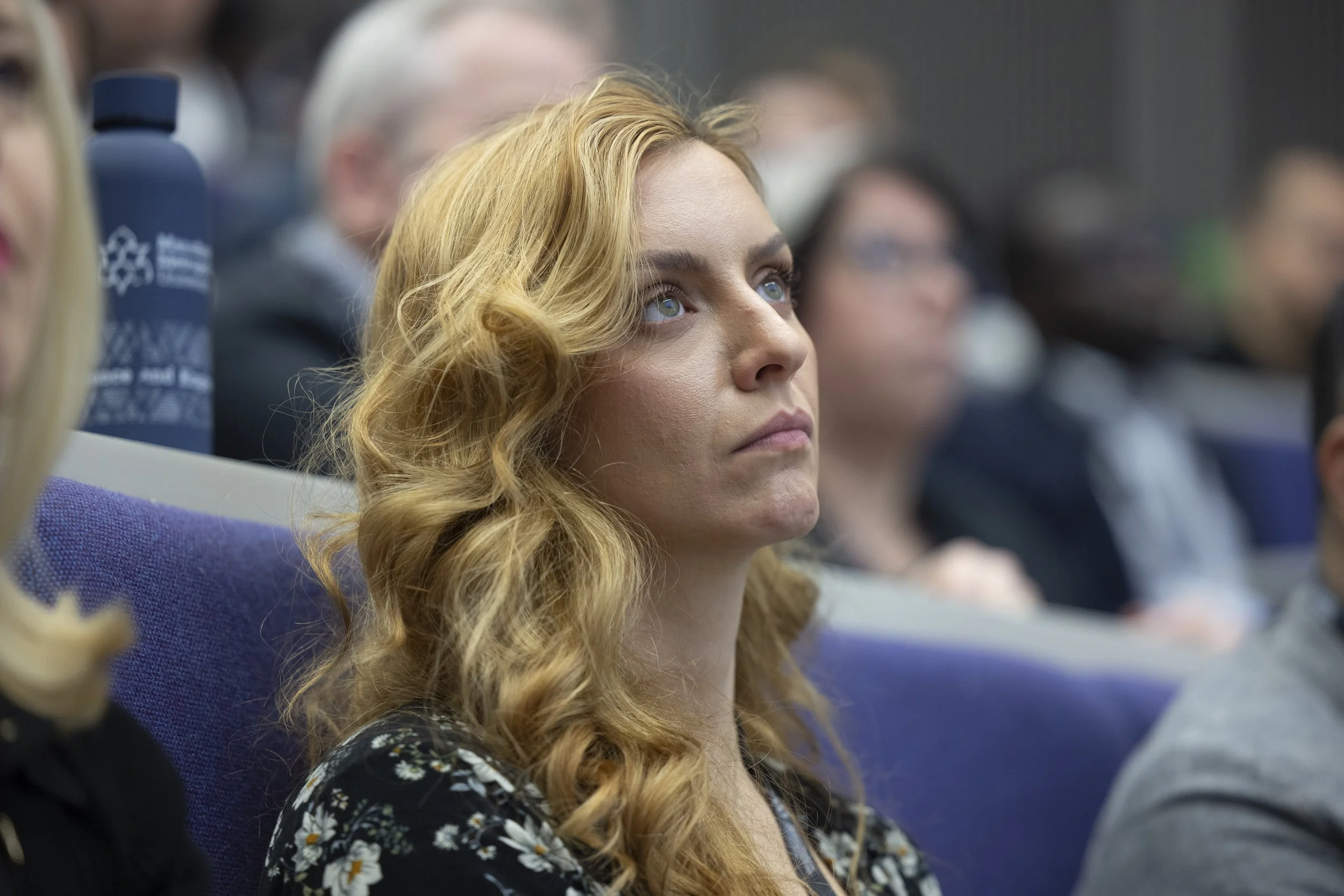 A woman viewing a projection during a conference in Manchester