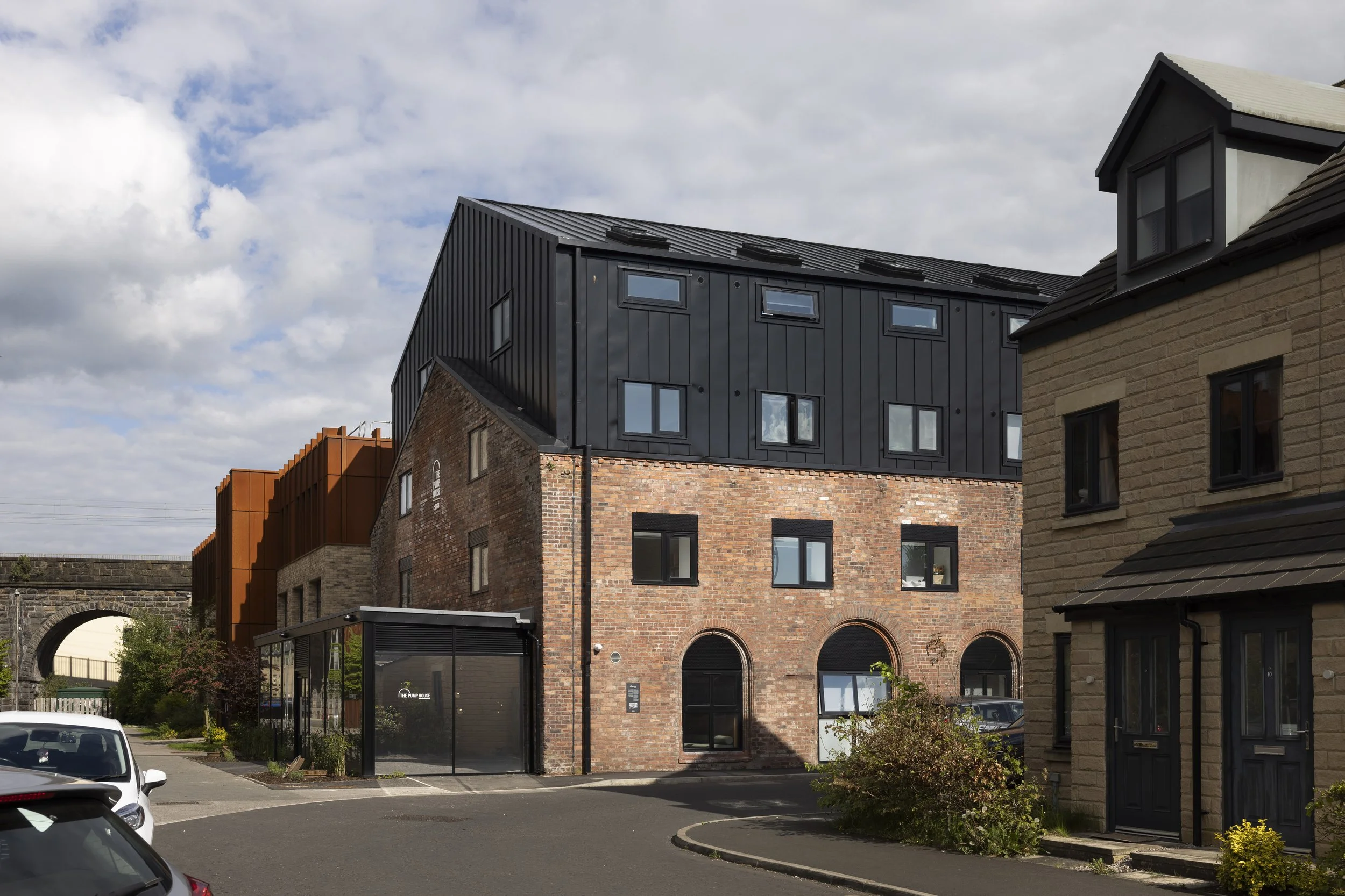 Front three-quarter exterior view of The Pump House by Just H Architects showing restored industrial architecture