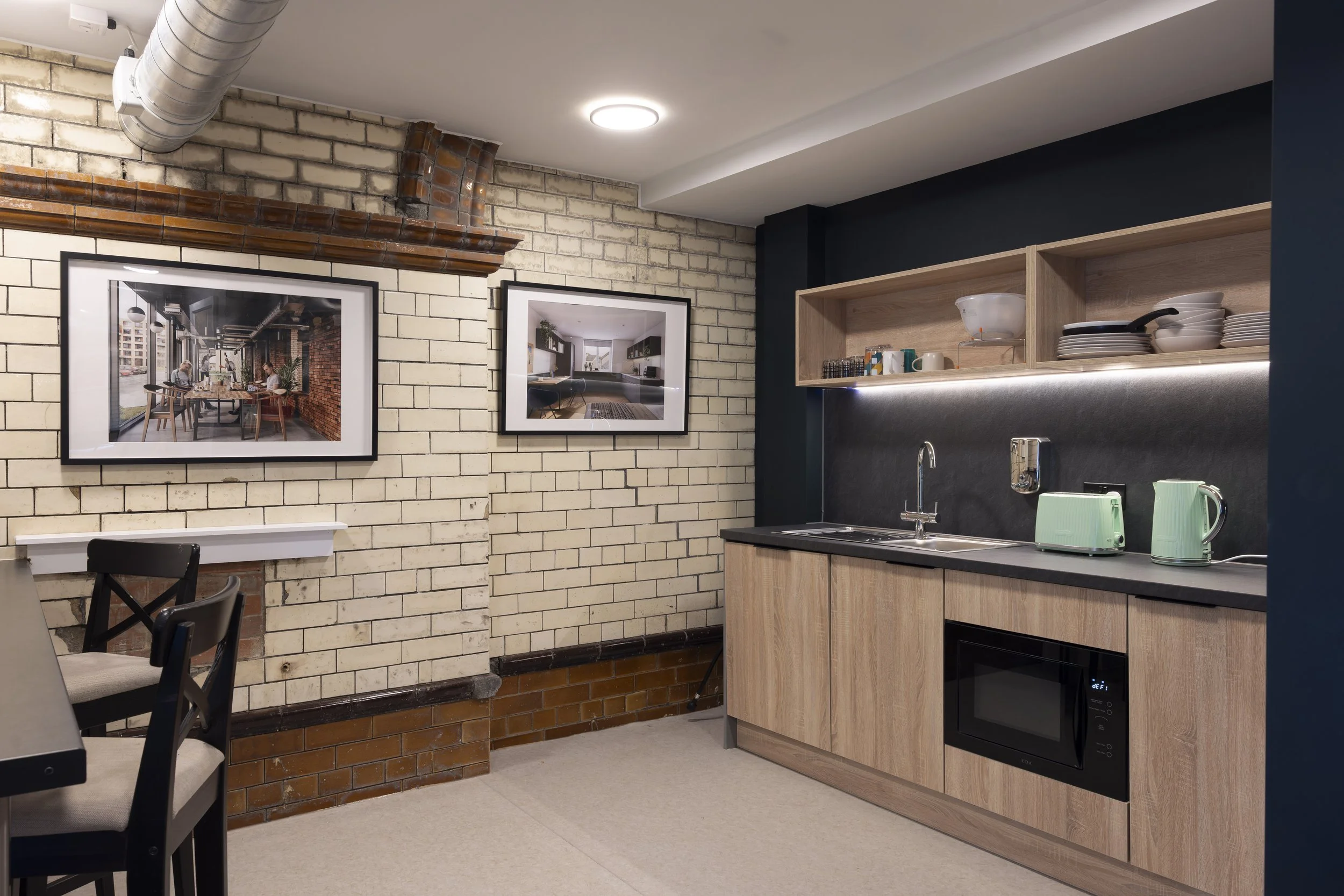 Interior kitchen space of The Pump House by Just H Architects and additional front three-quarter exterior view of the building