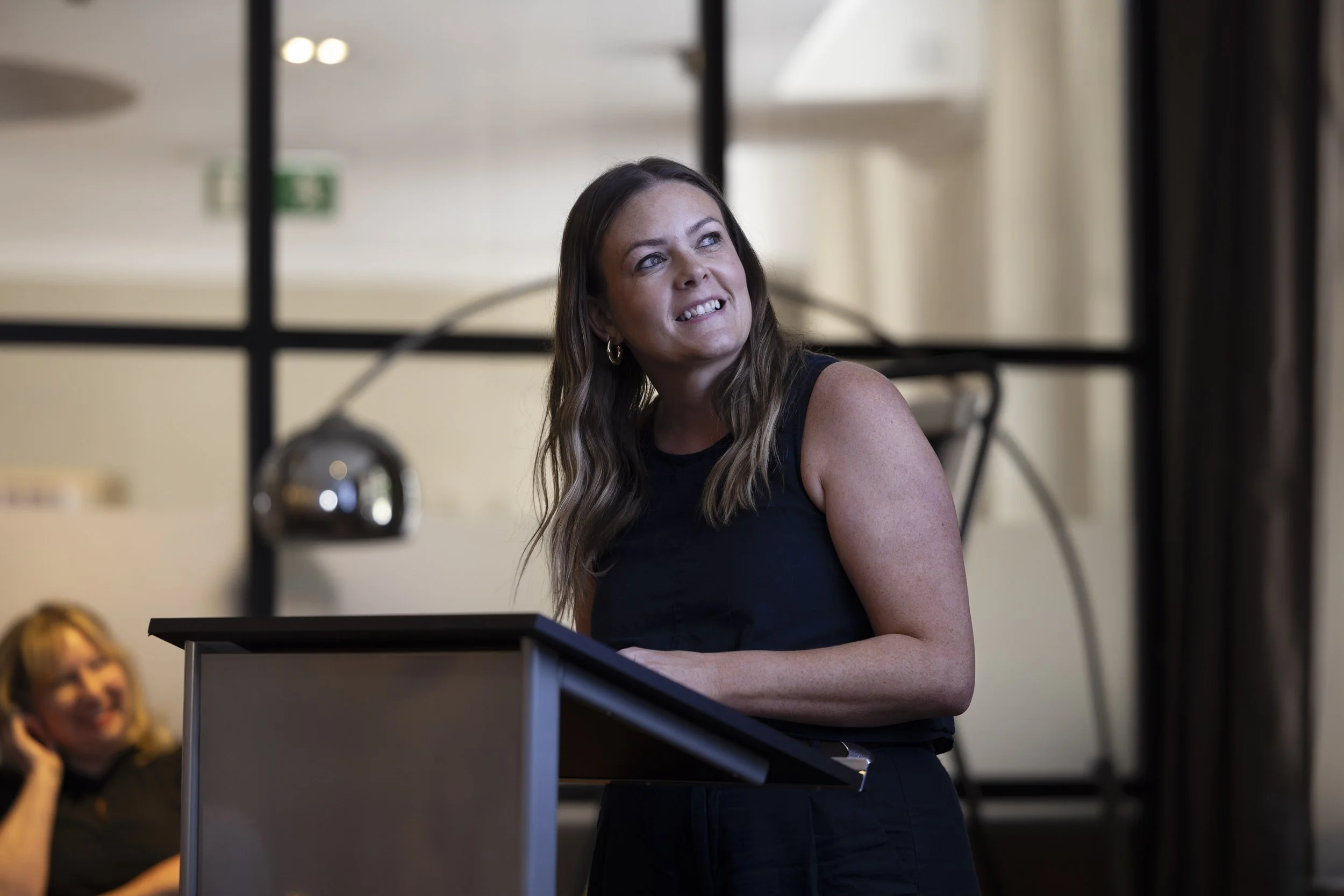 Woman smiling while presenting at a residential design event at the Townhouse Hotel, Manchester