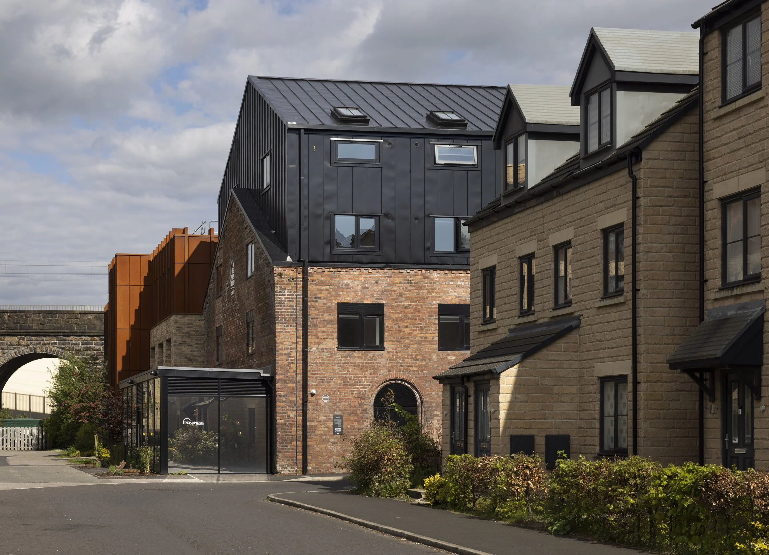 Front three-quarter exterior view of The Pump House by Just H Architects showing restored industrial architecture
