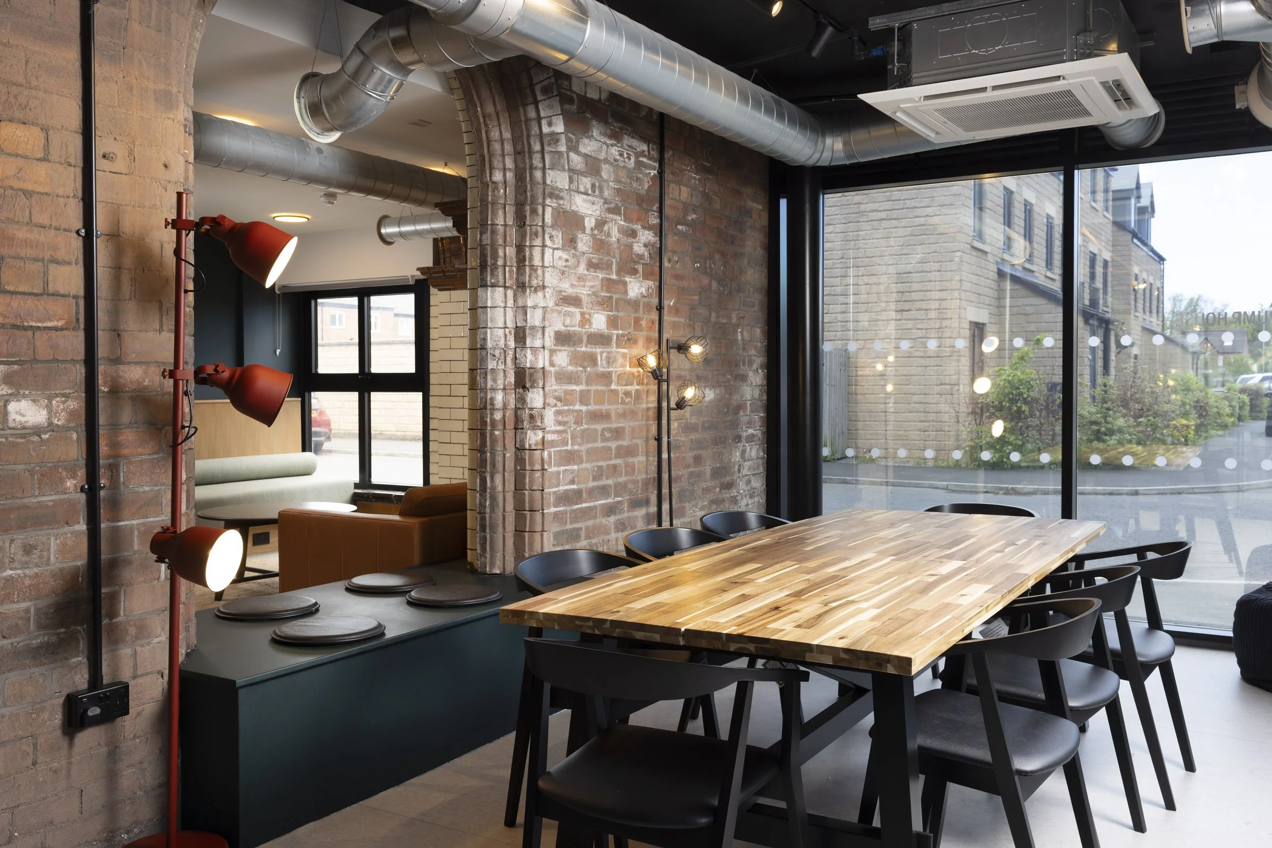 Interior of The Pump House by Just H Architects showing dining table within converted industrial space