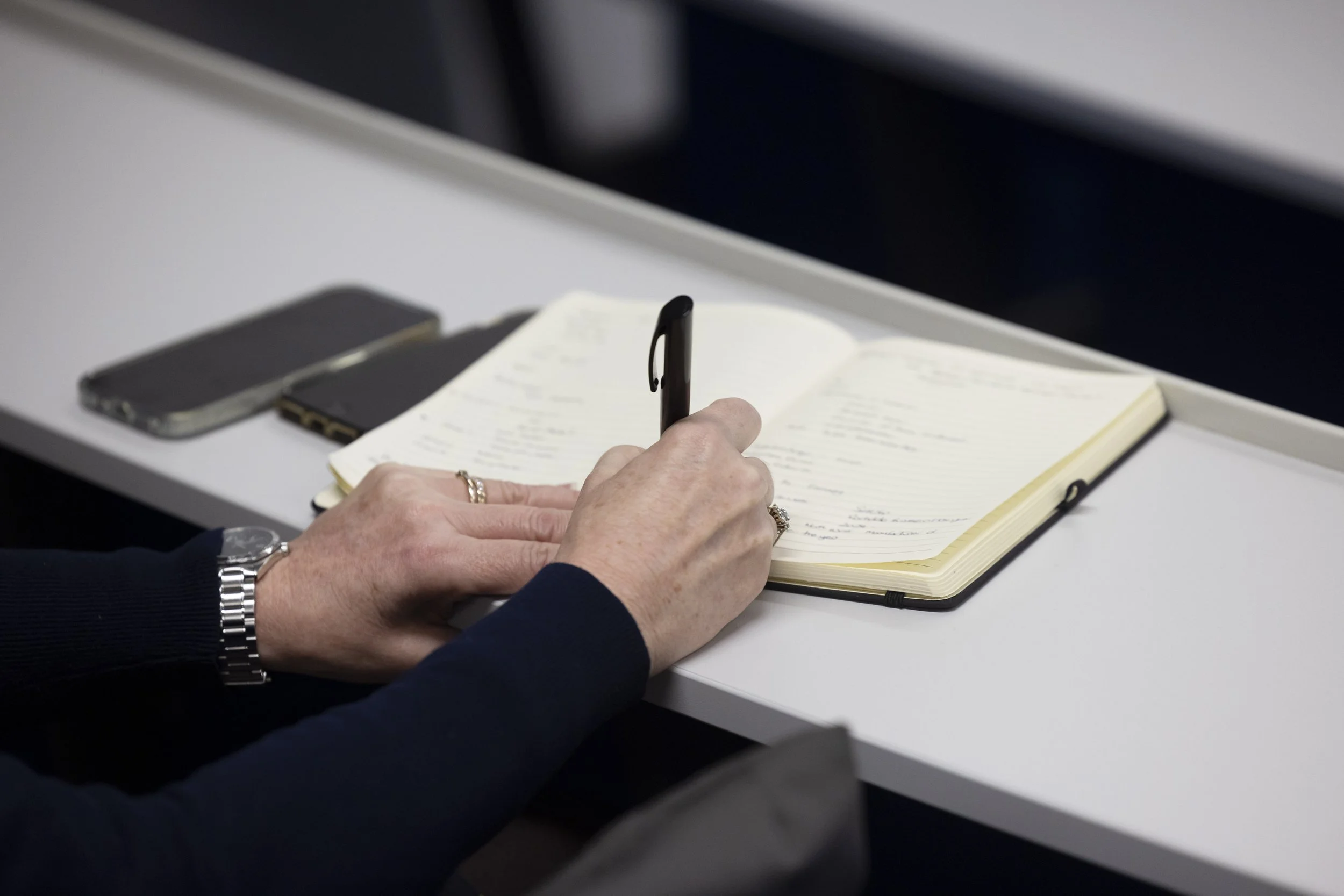 A delegate takes note during a presentation at a conference in Manchester