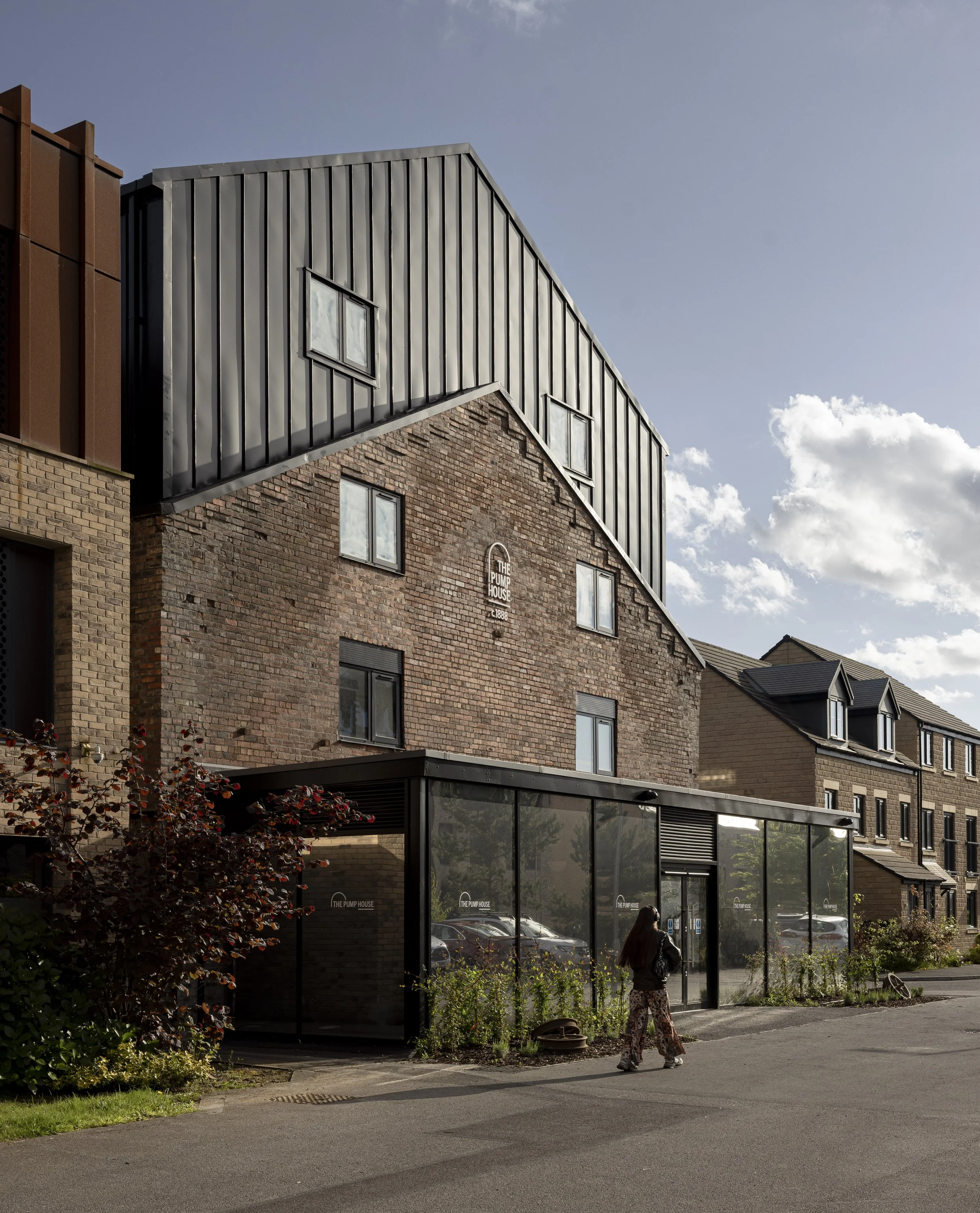 Front view of The Pump House by Just H Architects photographed in dusk light highlighting restored industrial façade
