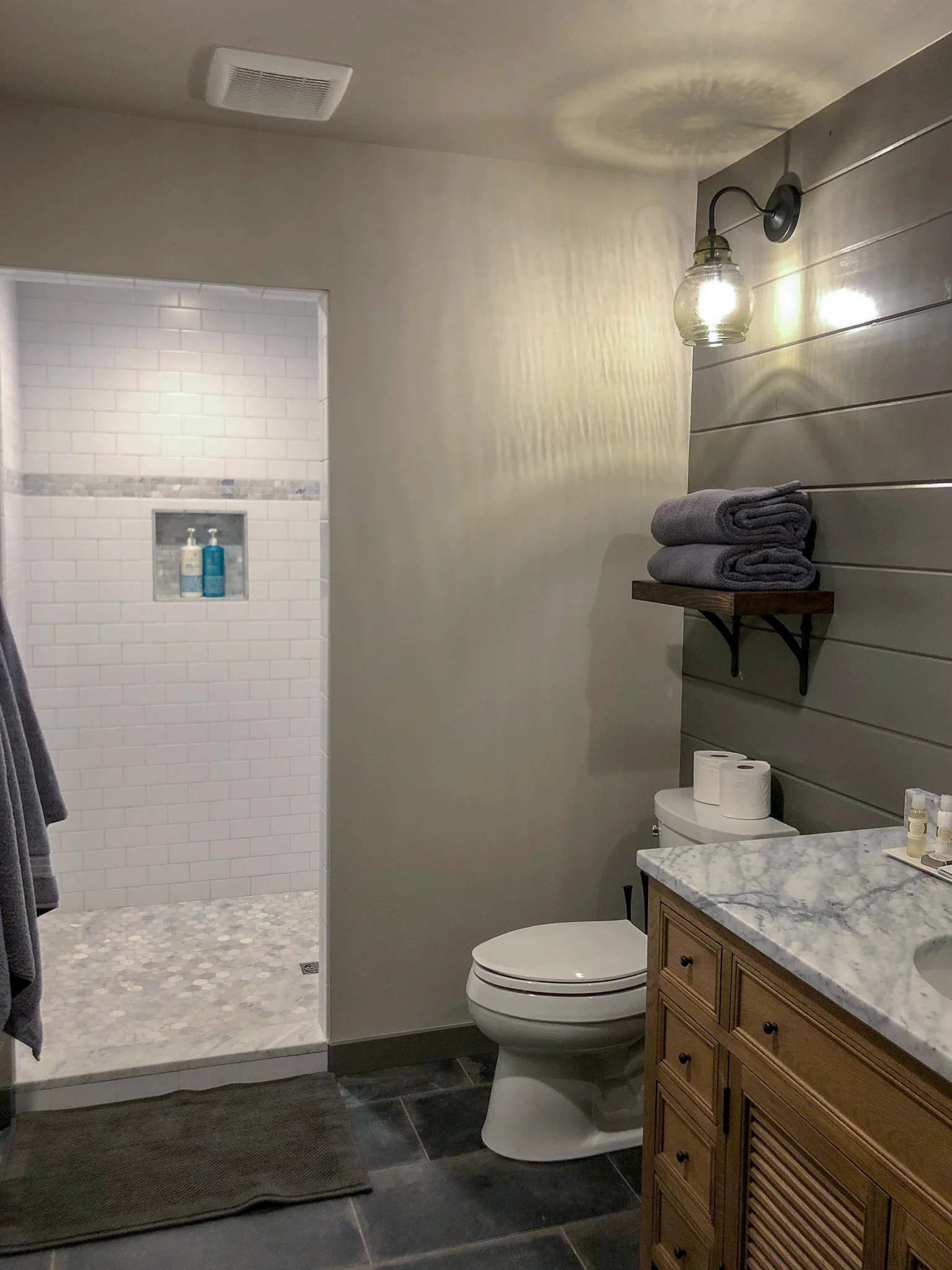 The custom shower has two shower heads - a rain shower and adjustable shower head