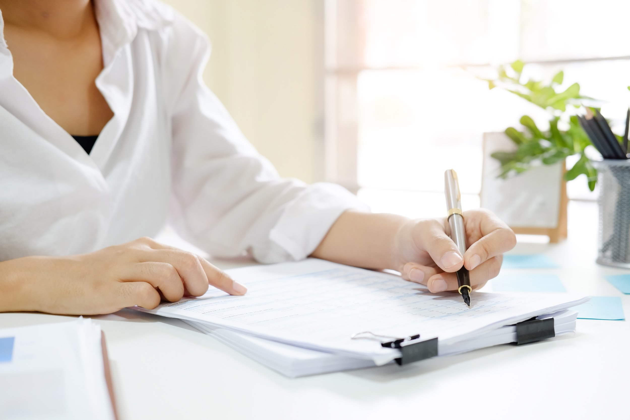 A rental property manager reviewing tenant applications and screening potential tenants.