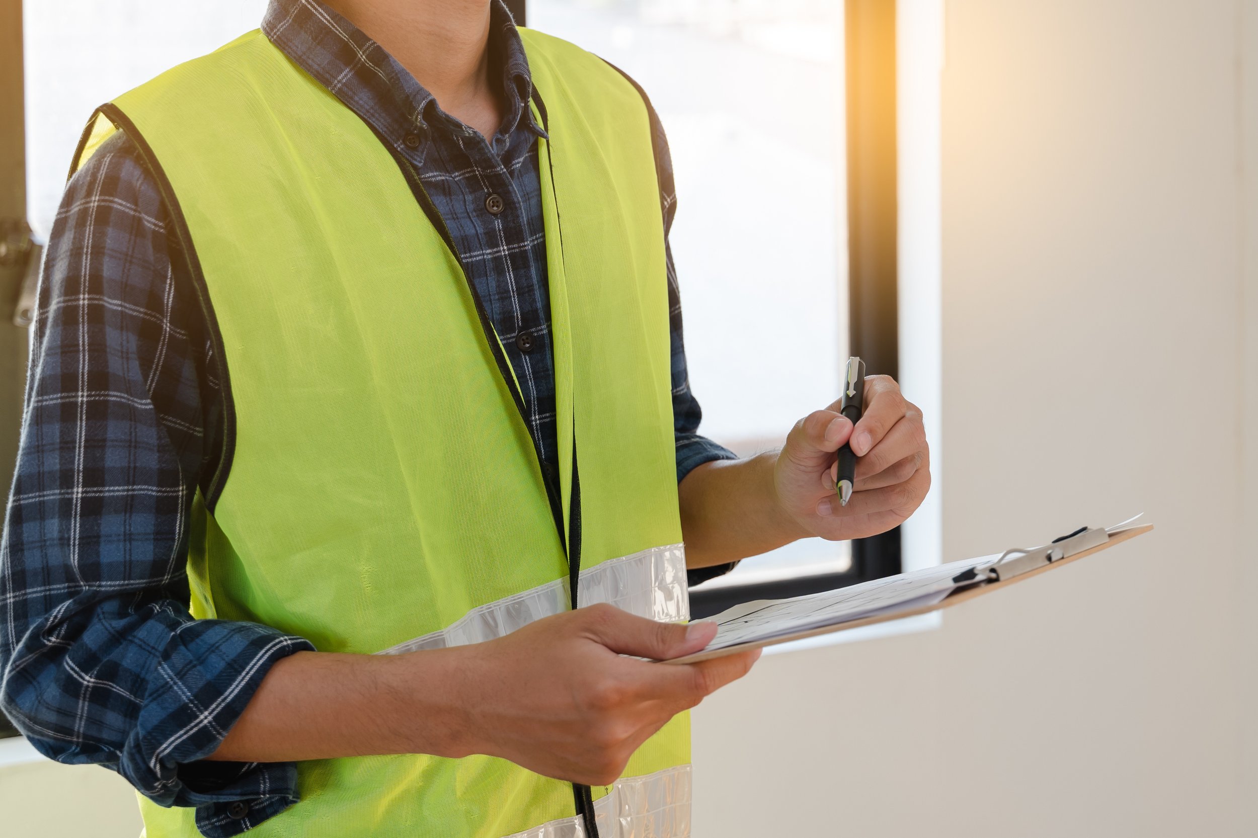 A property inspector conducting an inspection of a rental property with a checklist in hand.