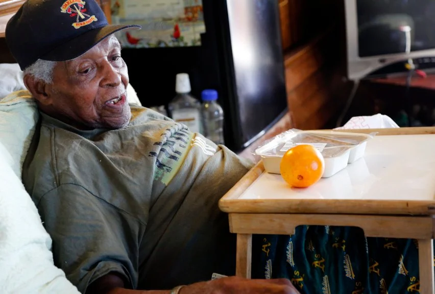  Milton Williams, 95, prepares to eat his meal from Meals on Wheels at his home in Oakland, Calif., on Wednesday, Nov. 16, 2016.  Williams has been a recipient of the Meals on Wheels program for about ten years, allowing him to live at his home of 40 years. (Laura A. Oda/Bay Area News Group) 