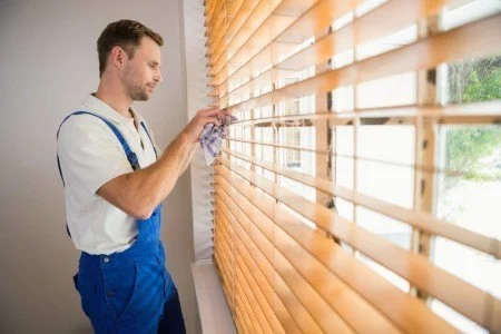 Man-cleaning-blinds-450x300.jpg
