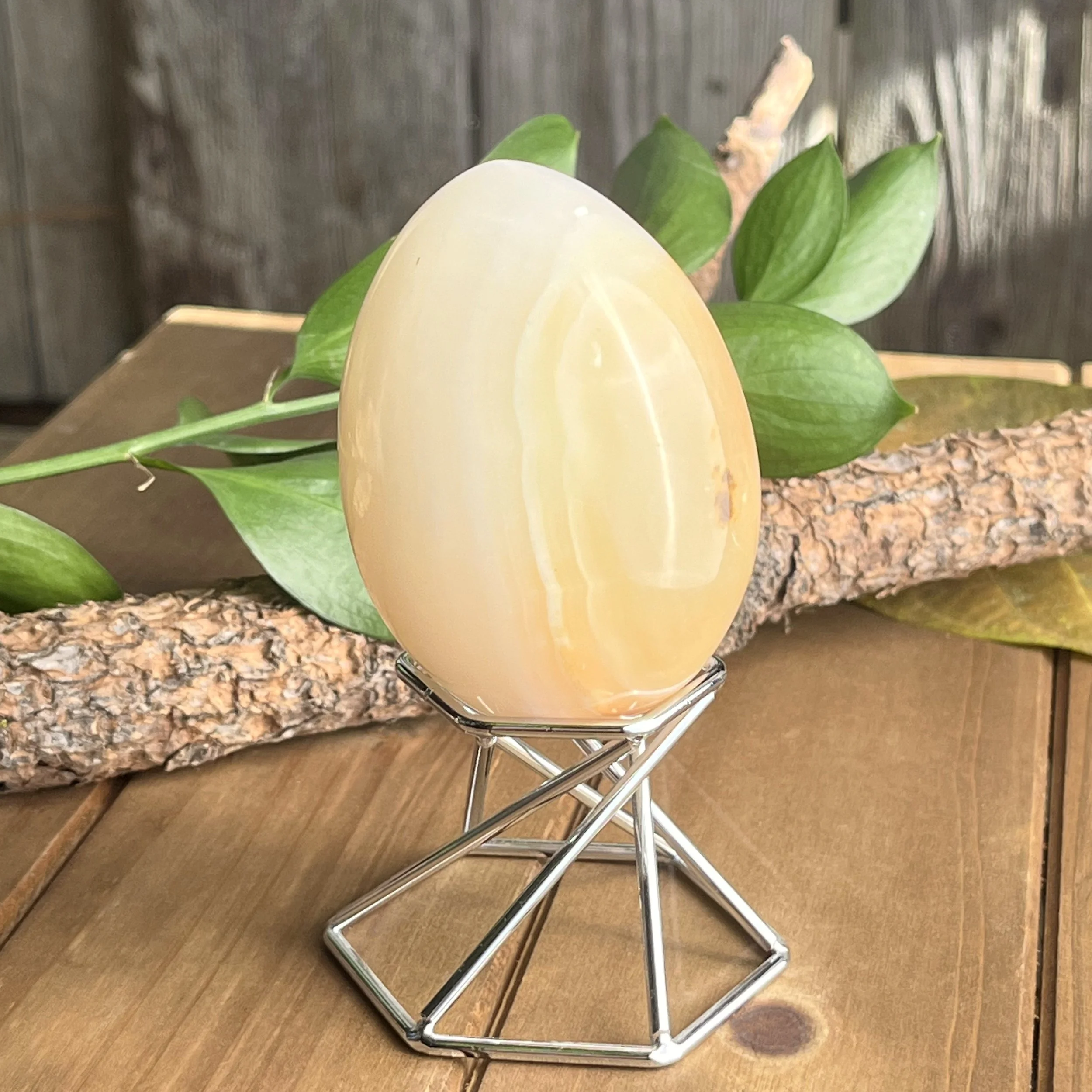 yellow calcite 4" egg with stand