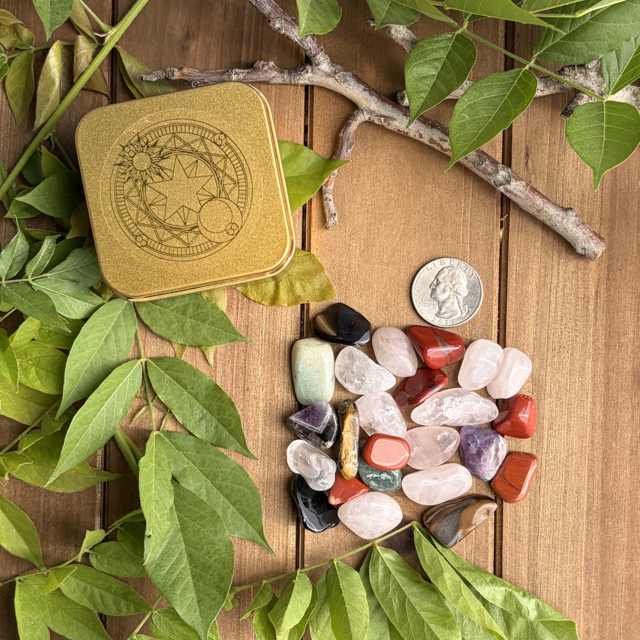 tin with mixed tumbled gemstones