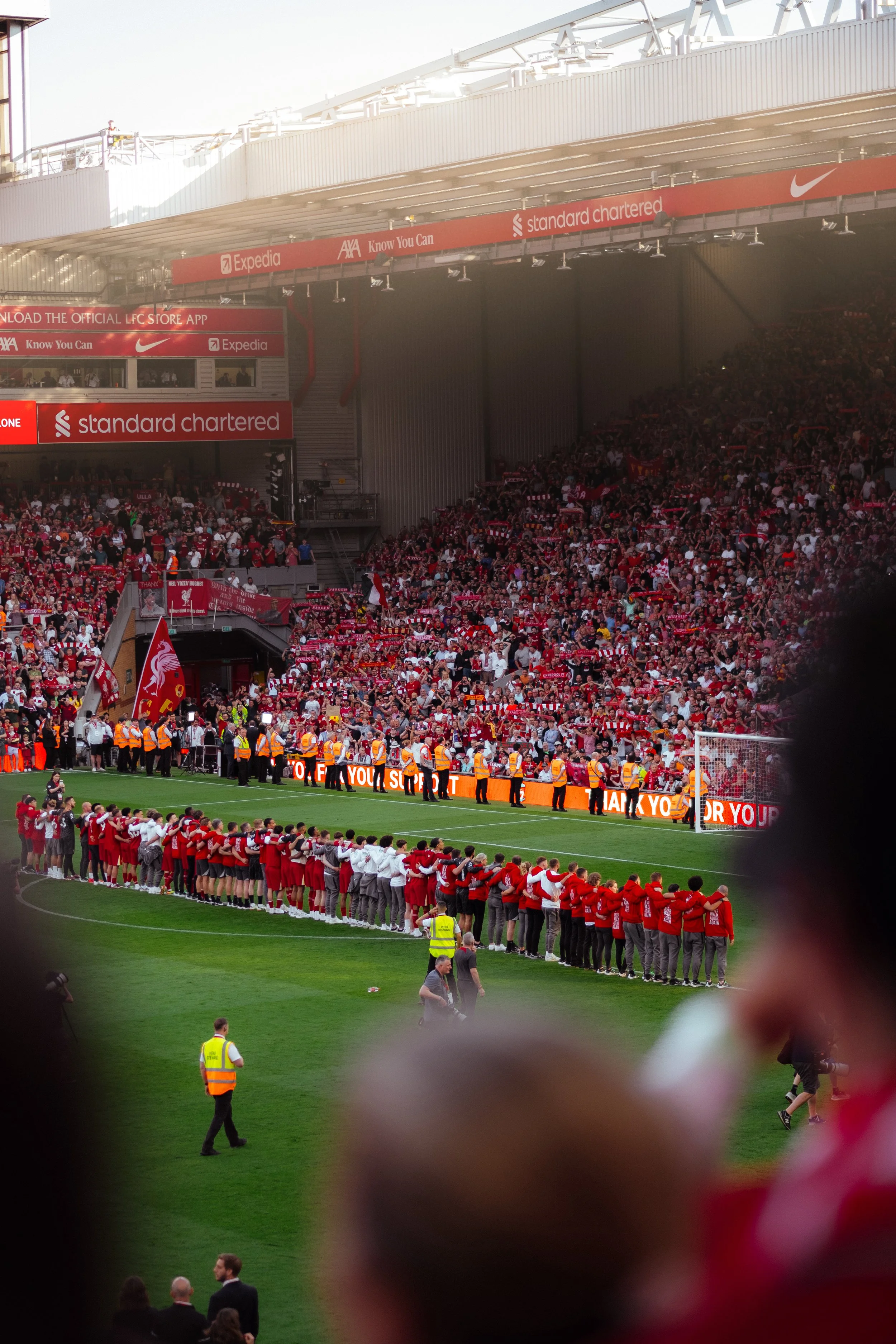 Liverpool FC match day at Anfield — aerial stadium view with players lining up, event photography