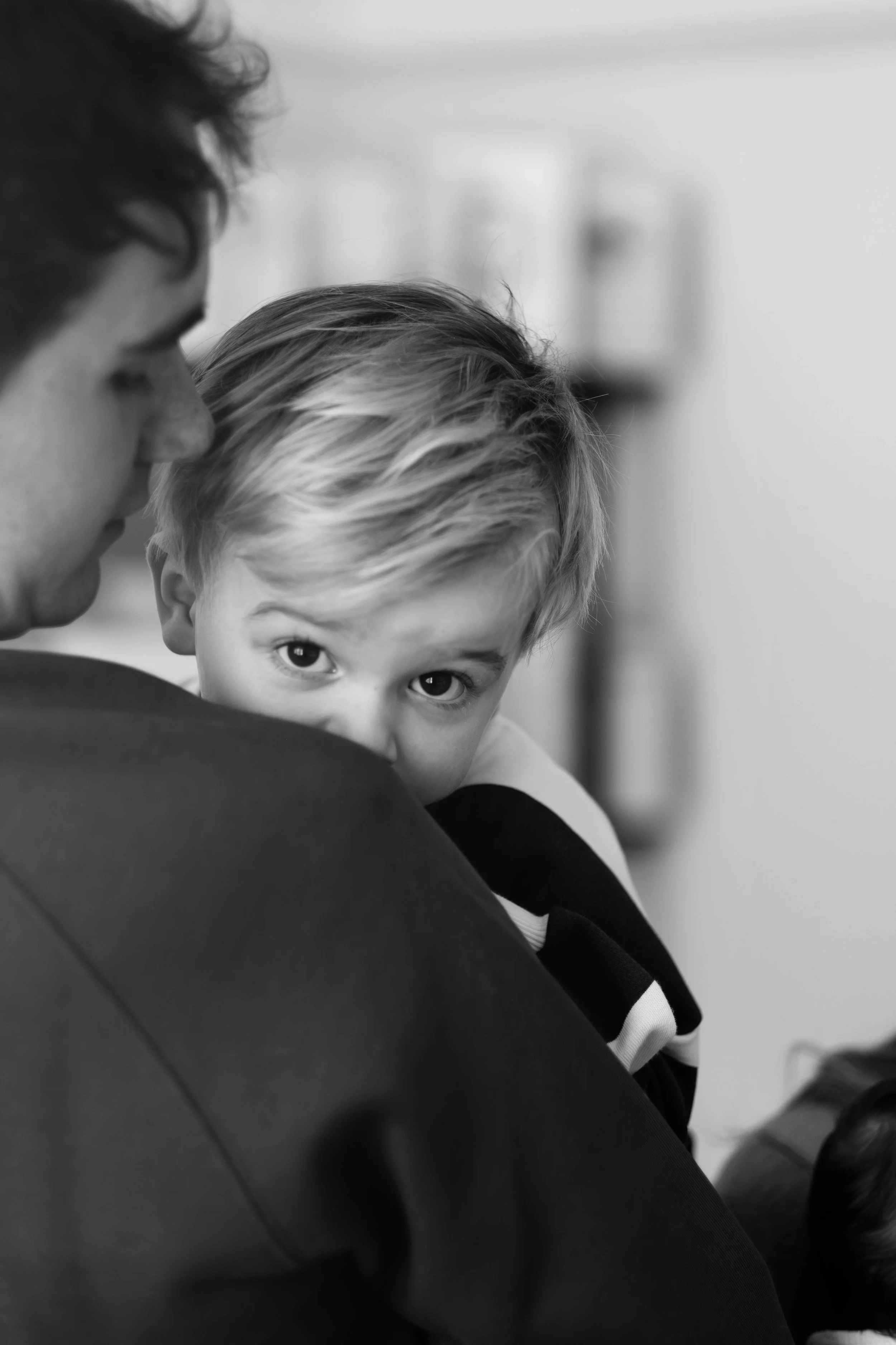 Candid close-up portrait of a young child — black and white family photography