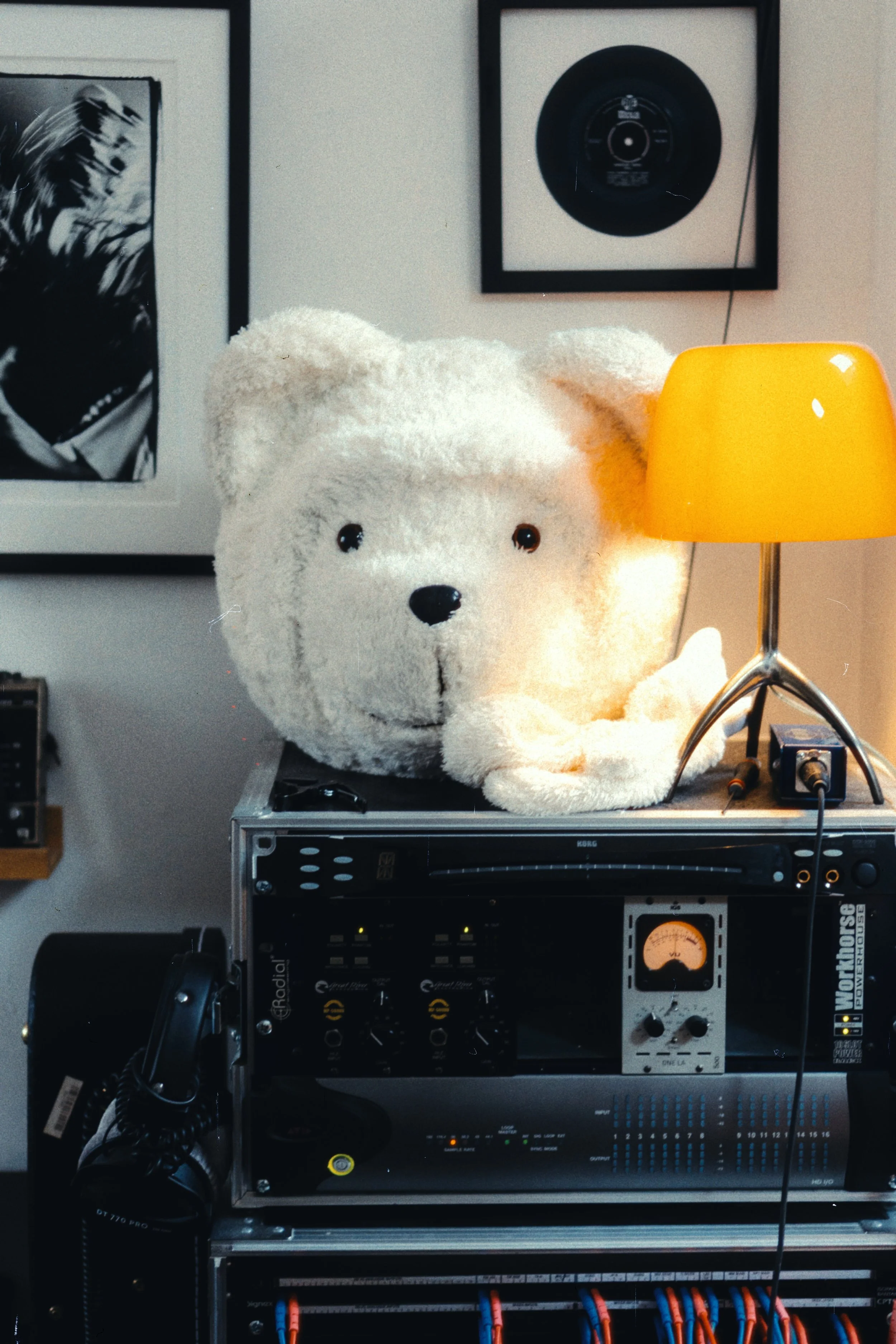 Teddy bear mascot in a home recording studio with audio equipment — creative still life