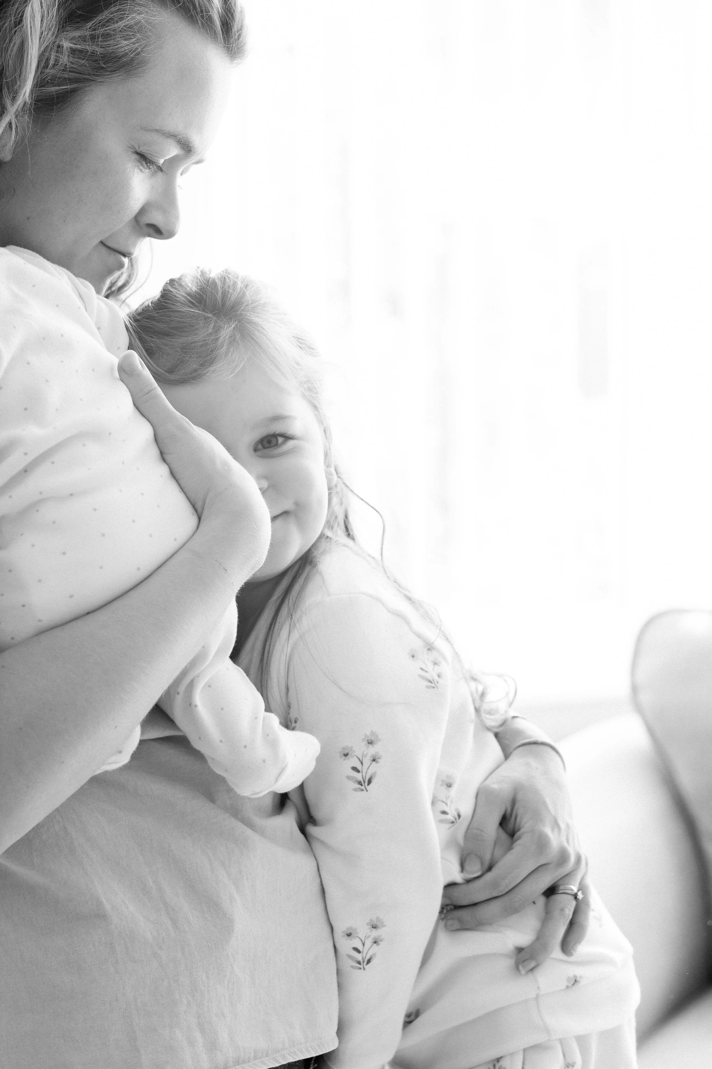 Mother cradling newborn baby — family and newborn photography, Liverpool