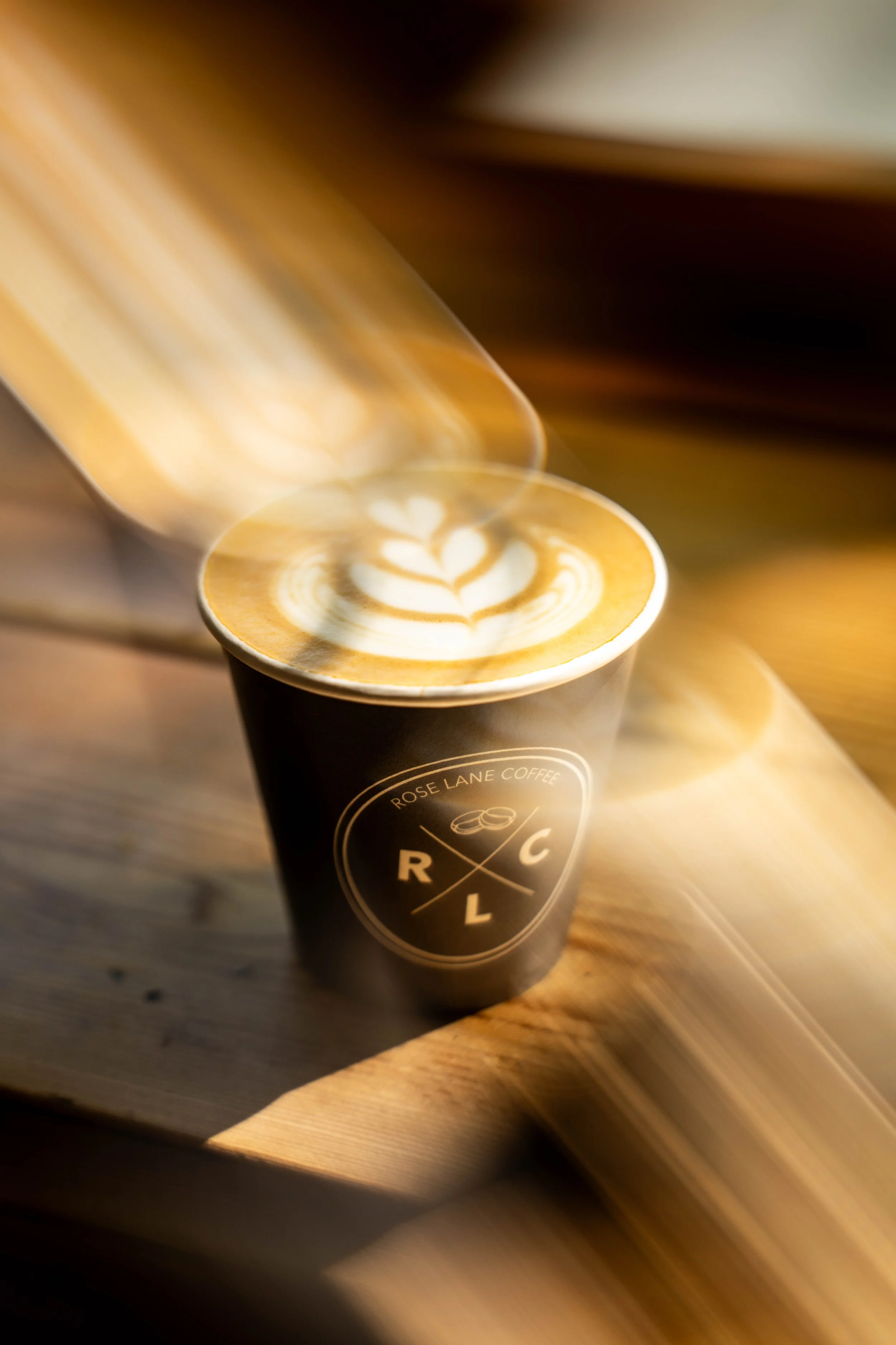 Latte art coffee cup — RCL brand commercial product photography