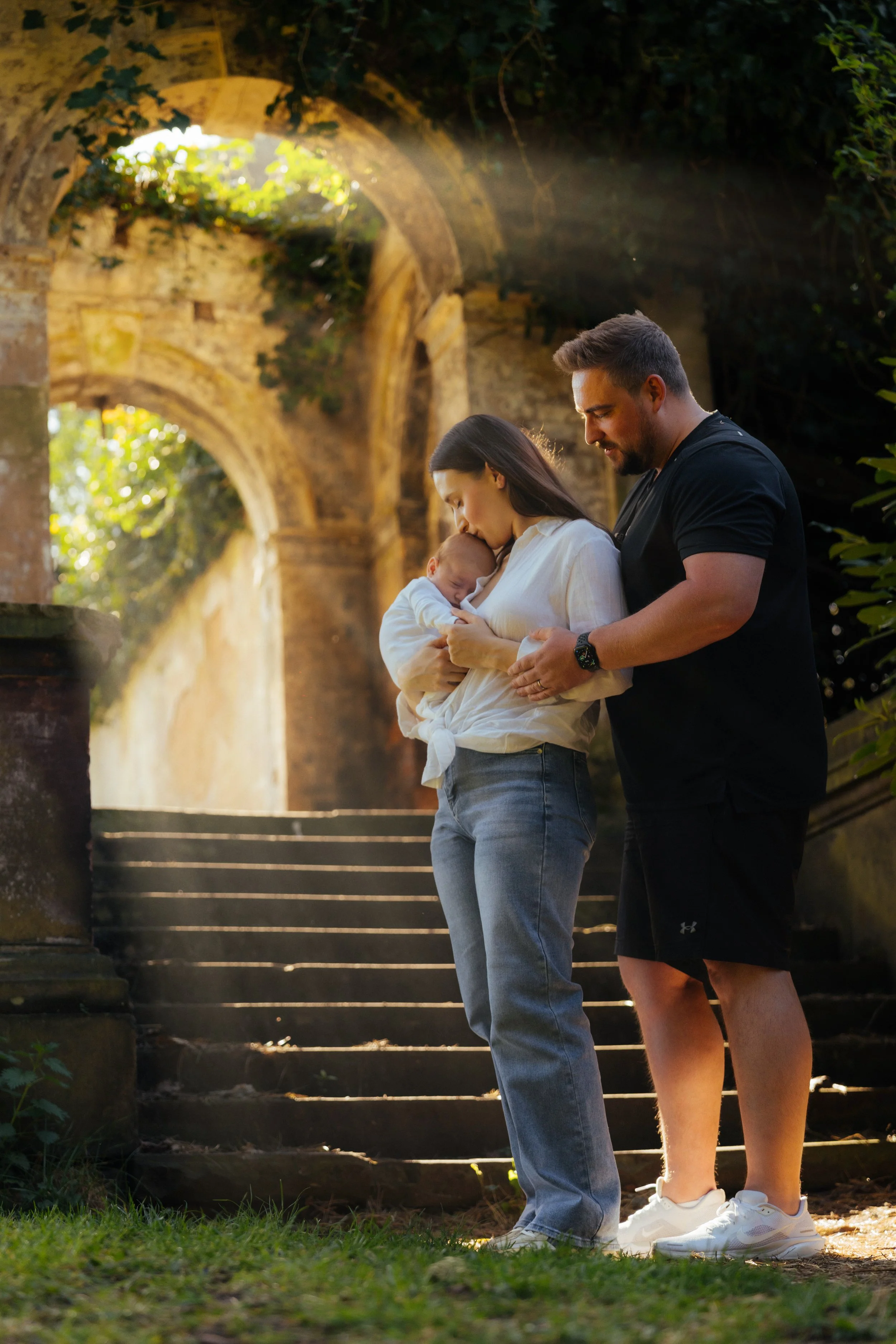 Family portrait on stone steps with archway — outdoor location family photography, Liverpool