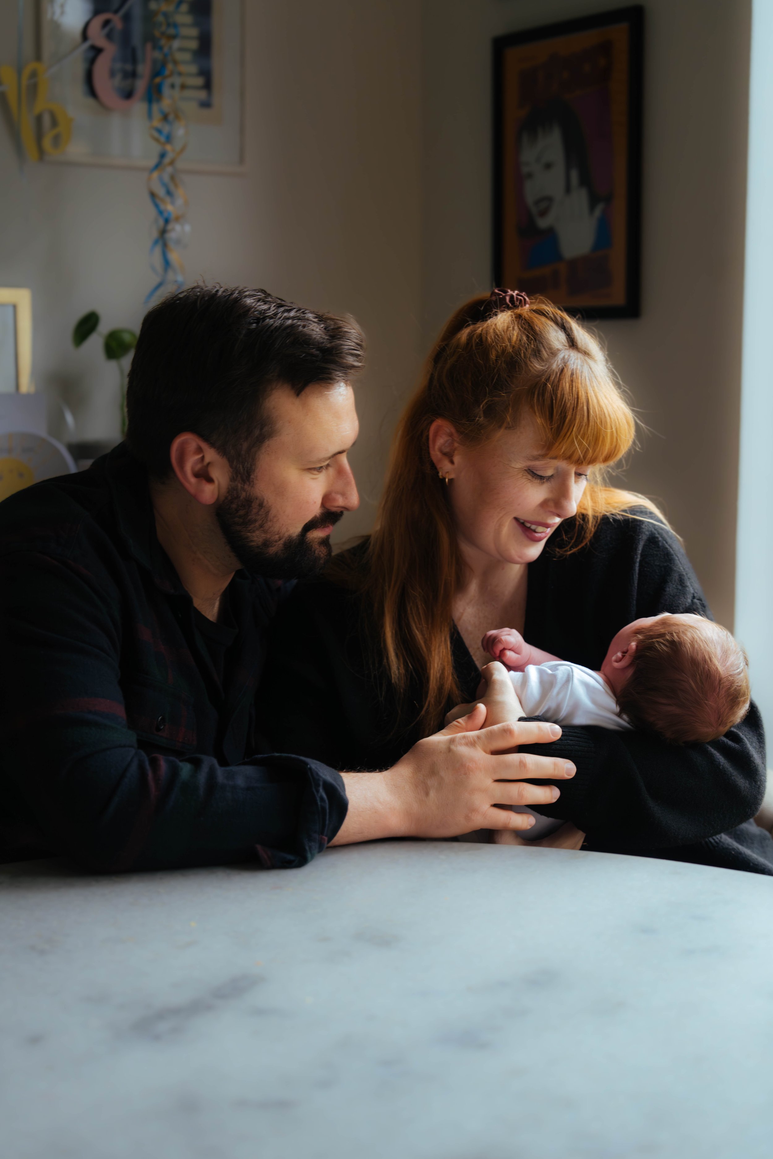 New parents smiling at their newborn baby — family lifestyle photography, Liverpool