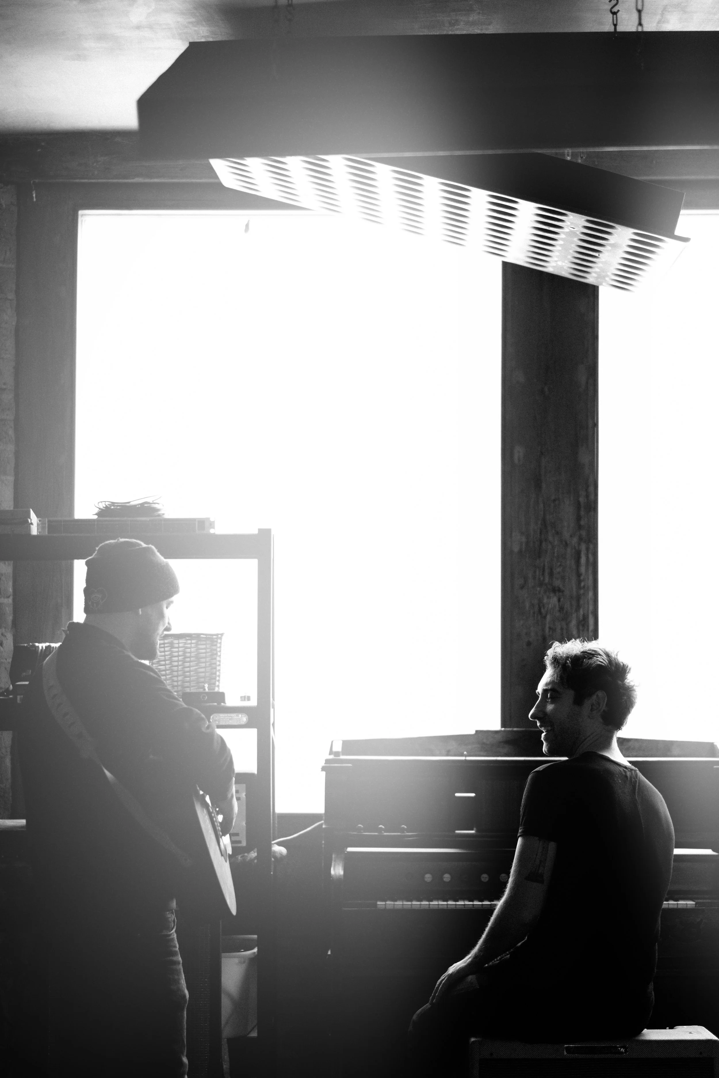 Two people silhouetted in a cafe or bar — candid lifestyle photography
