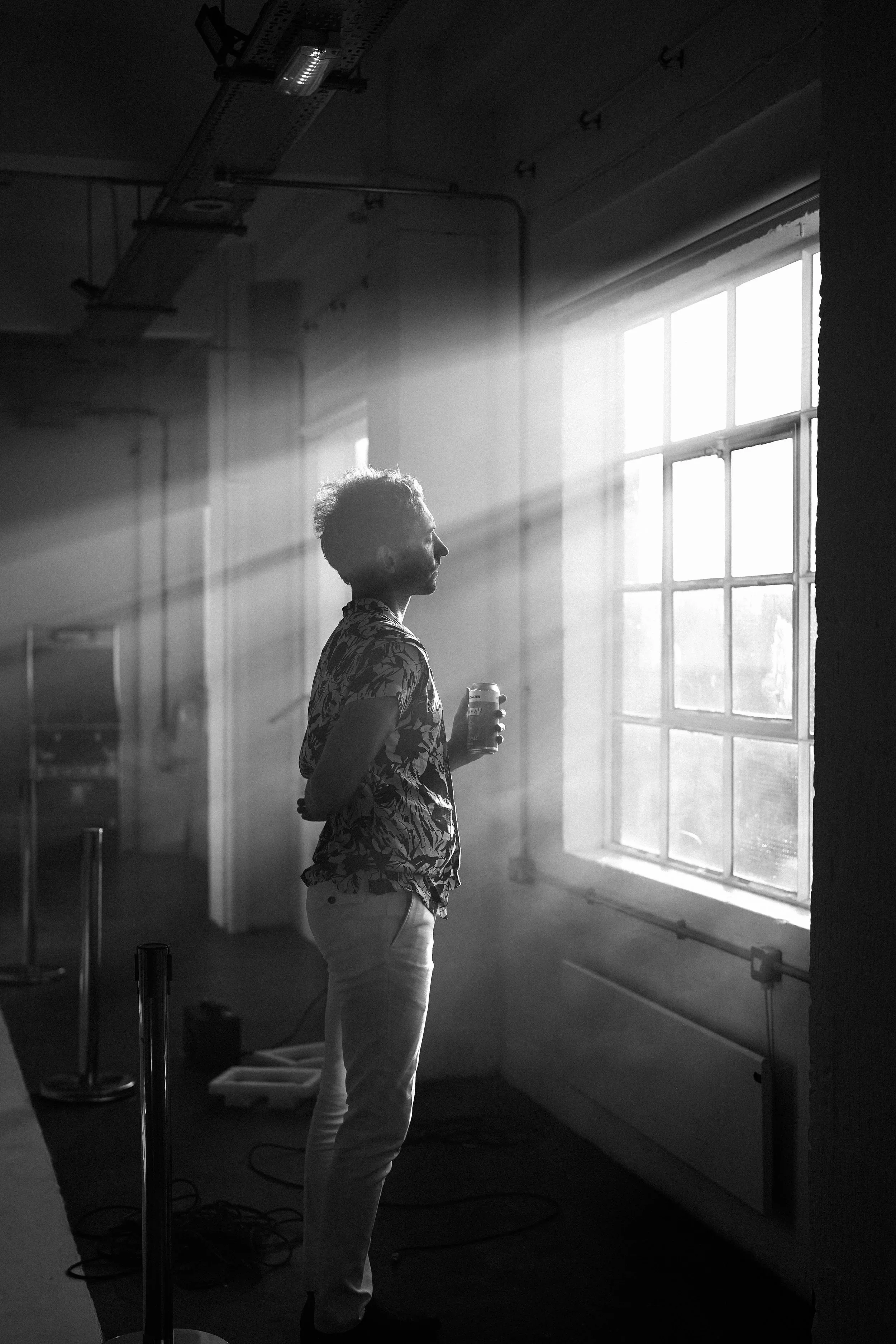 Moody atmospheric photography — figure in doorway or corridor, dramatic light