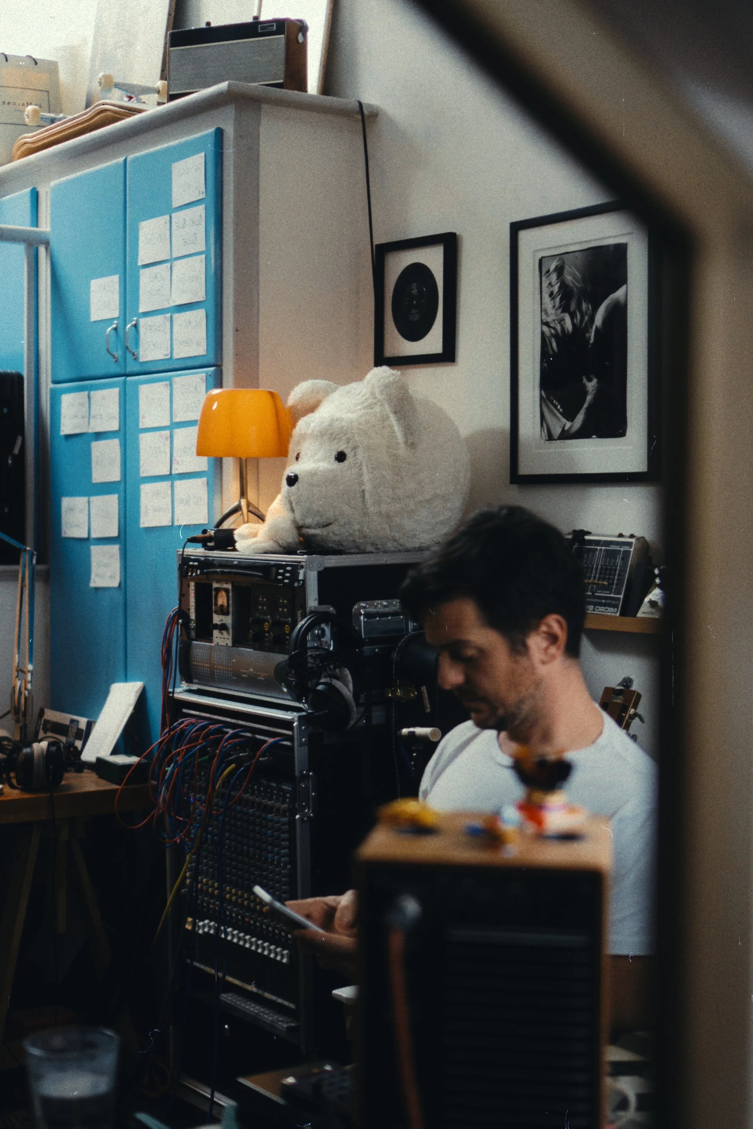 Recording studio session — musician at equipment in creative home studio, Liverpool