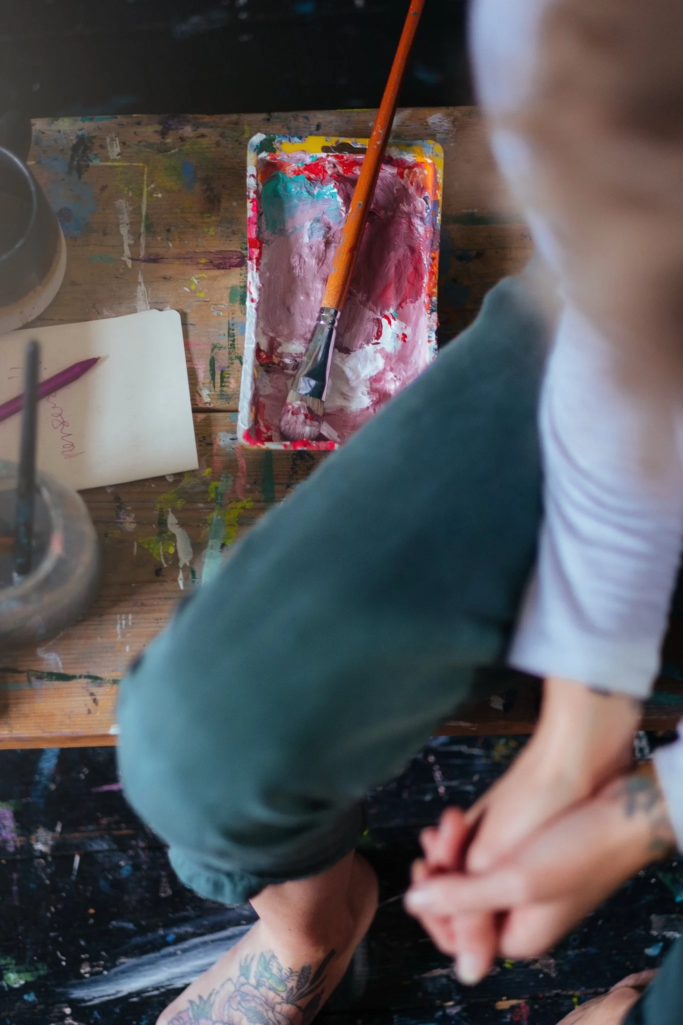 Artist working on the floor — creative behind the scenes photography